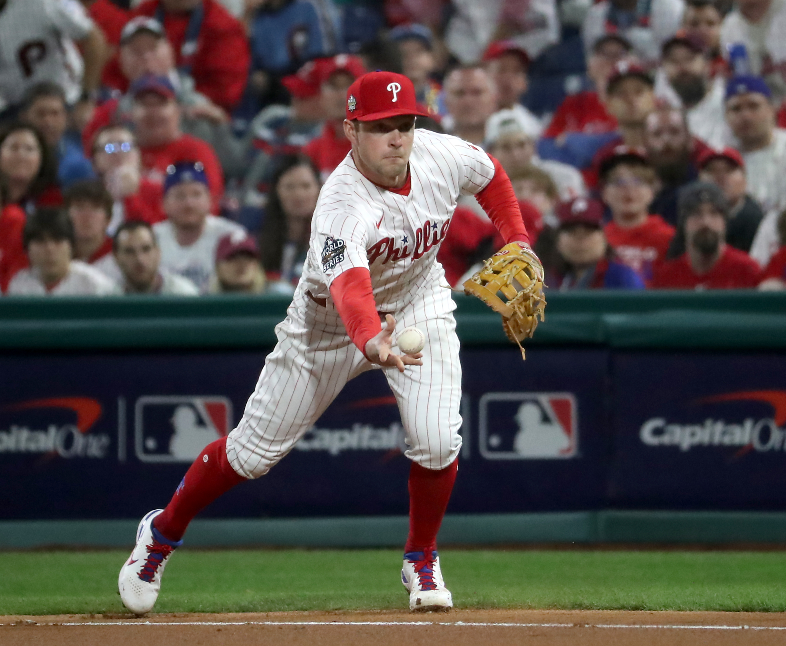 Rhys Hoskins (17) of the Philadelphia Phillies fields the ball and tosses it to Ranger Suarez (55) at first base for the out in the fourth inning during World Series Game 3 against the Houston Astros at Citizens Bank Park, Tuesday, Nov. 1, 2022.