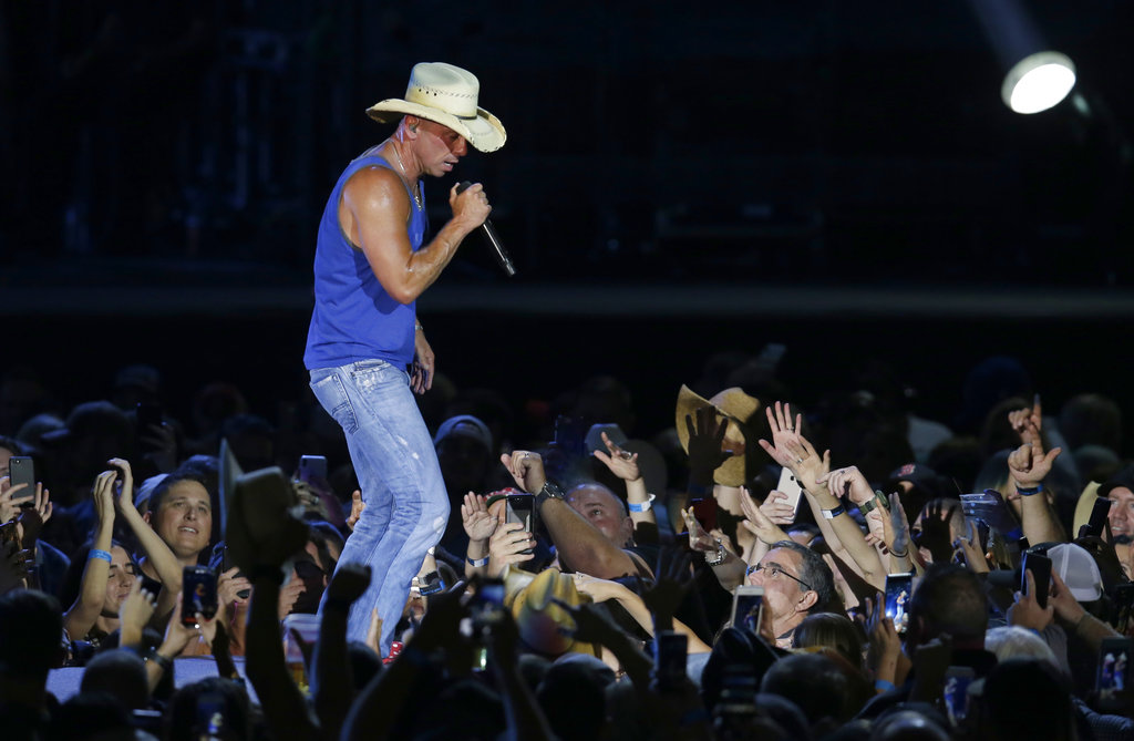 Woman dies after falling from escalator at Kenny Chesney concert, police say