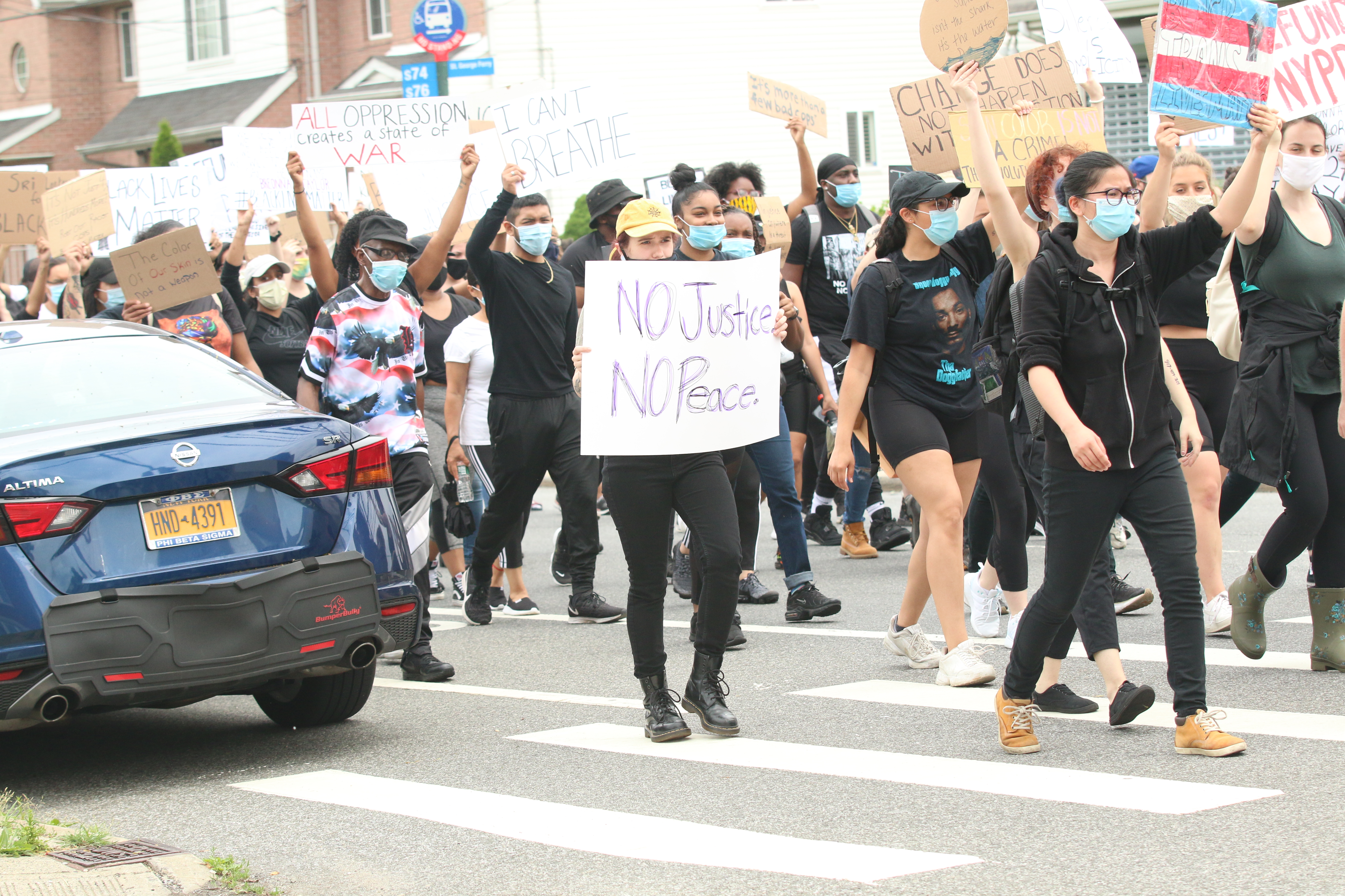 Protesters march to the 122 precinct through Dongan Hills along Richmond Road.  (Staten Island Advance/Jan Somma-Hammel)