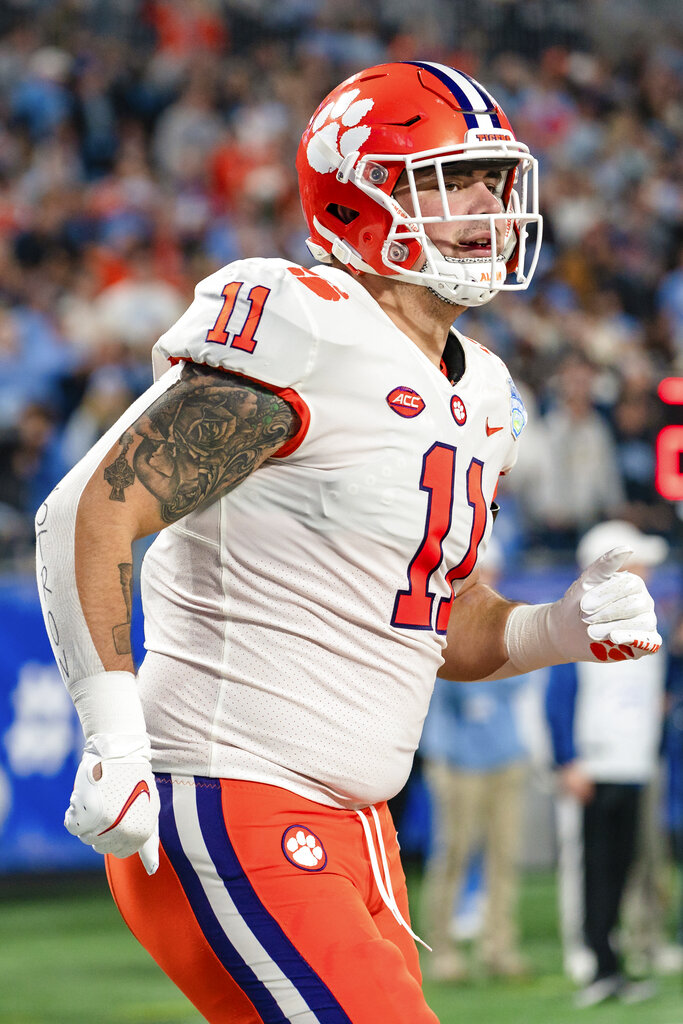 FILE - Ohio State quarterback Justin Fields is sacked by Clemson defensive  lineman Bryan Bresee during the second half of the Sugar Bowl NCAA college  football game in New Orleans, Jan. 1