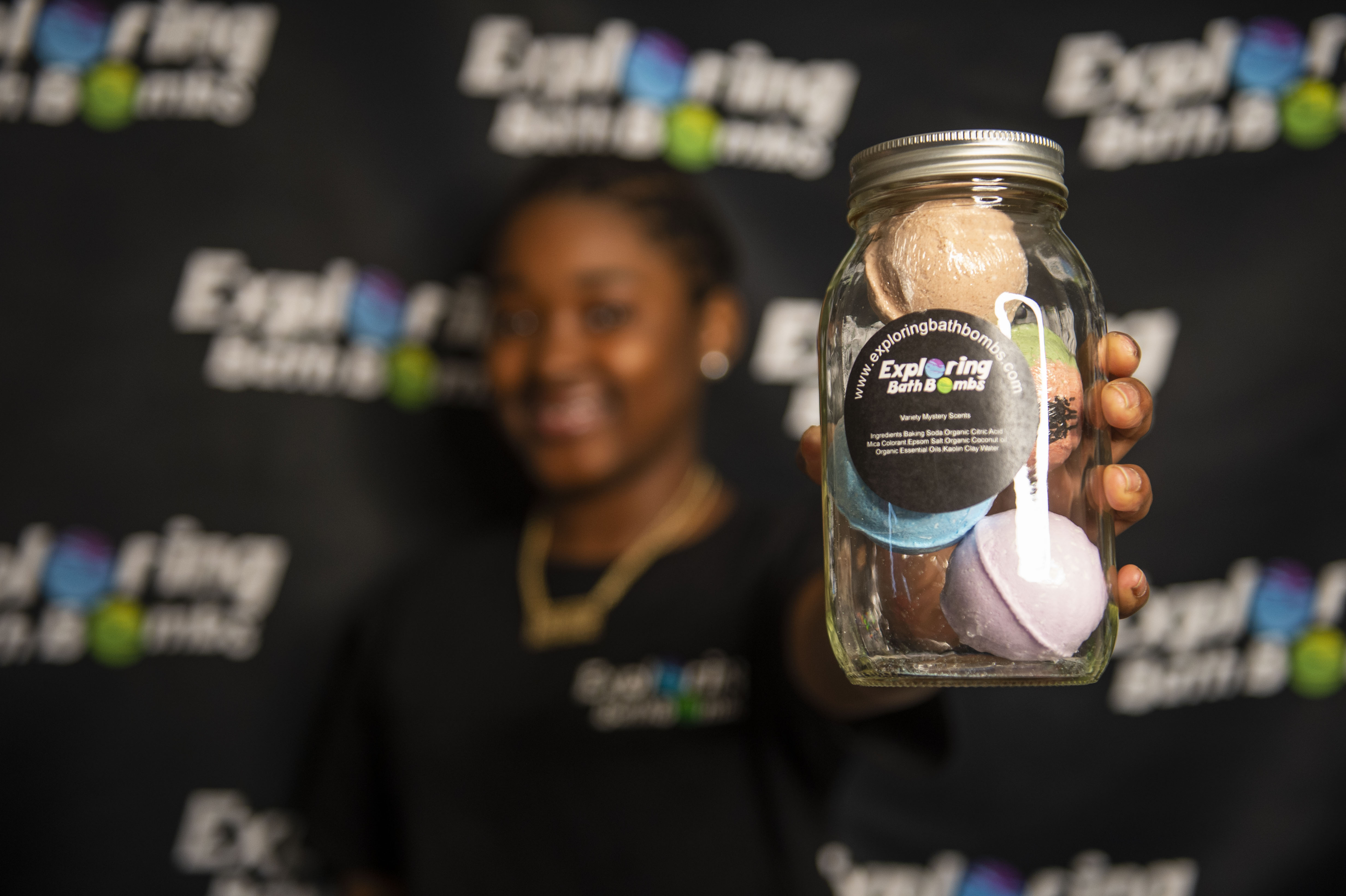 Sa'Veya Jackson, 11, holds a jar of bath bombs for her business Exploring Bath Bombs on Thursday, April 22, 2021. (Kaytie Boomer | MLive.com)