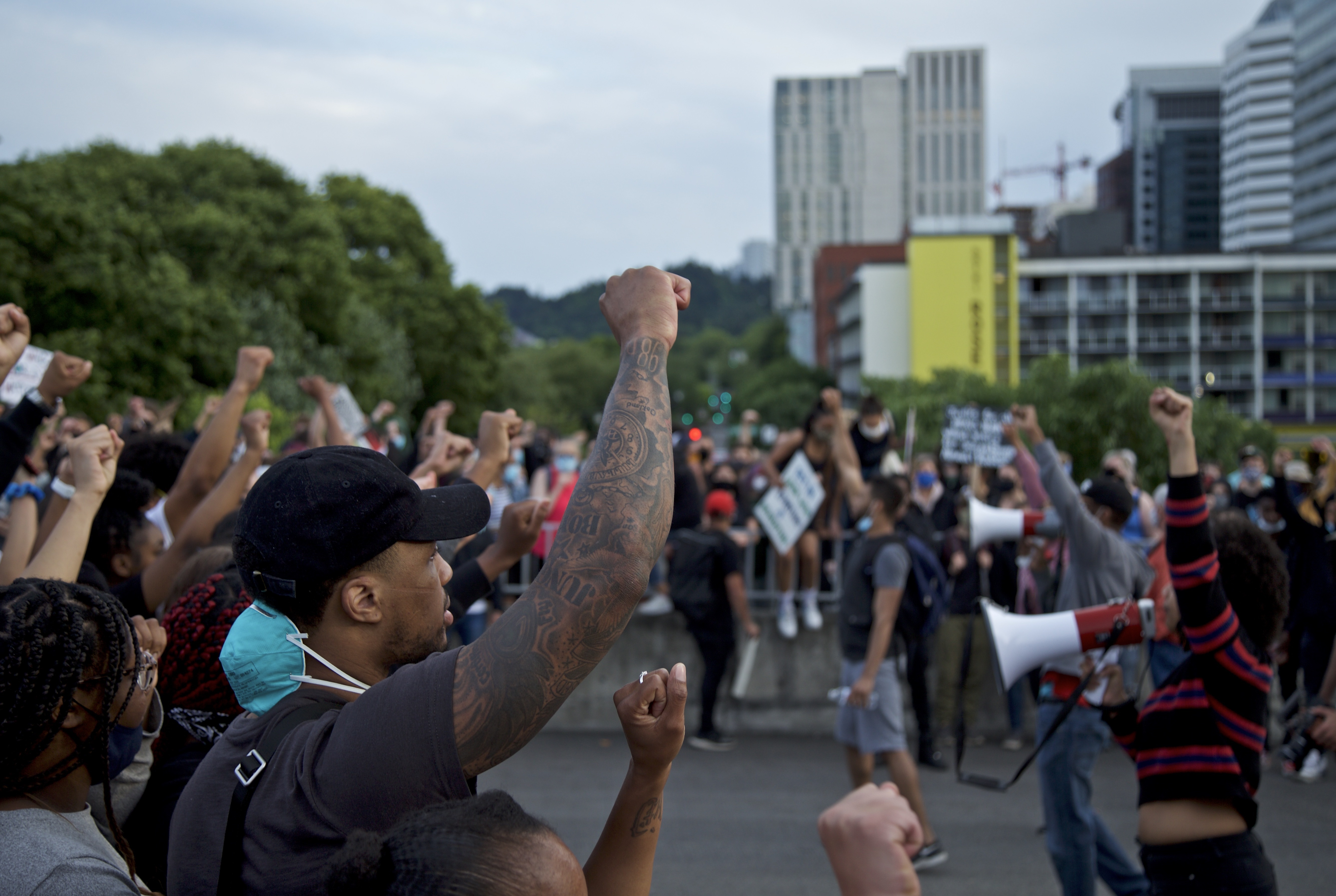 Portland Trail Blazers' Damian Lillard, left, joins other demonstrators in Portland, Ore., during a protest against police brutality and racism, sparked by the death of George Floyd, who died May 25 after being restrained by police in Minneapolis. (AP Photo/Craig Mitchelldyer)