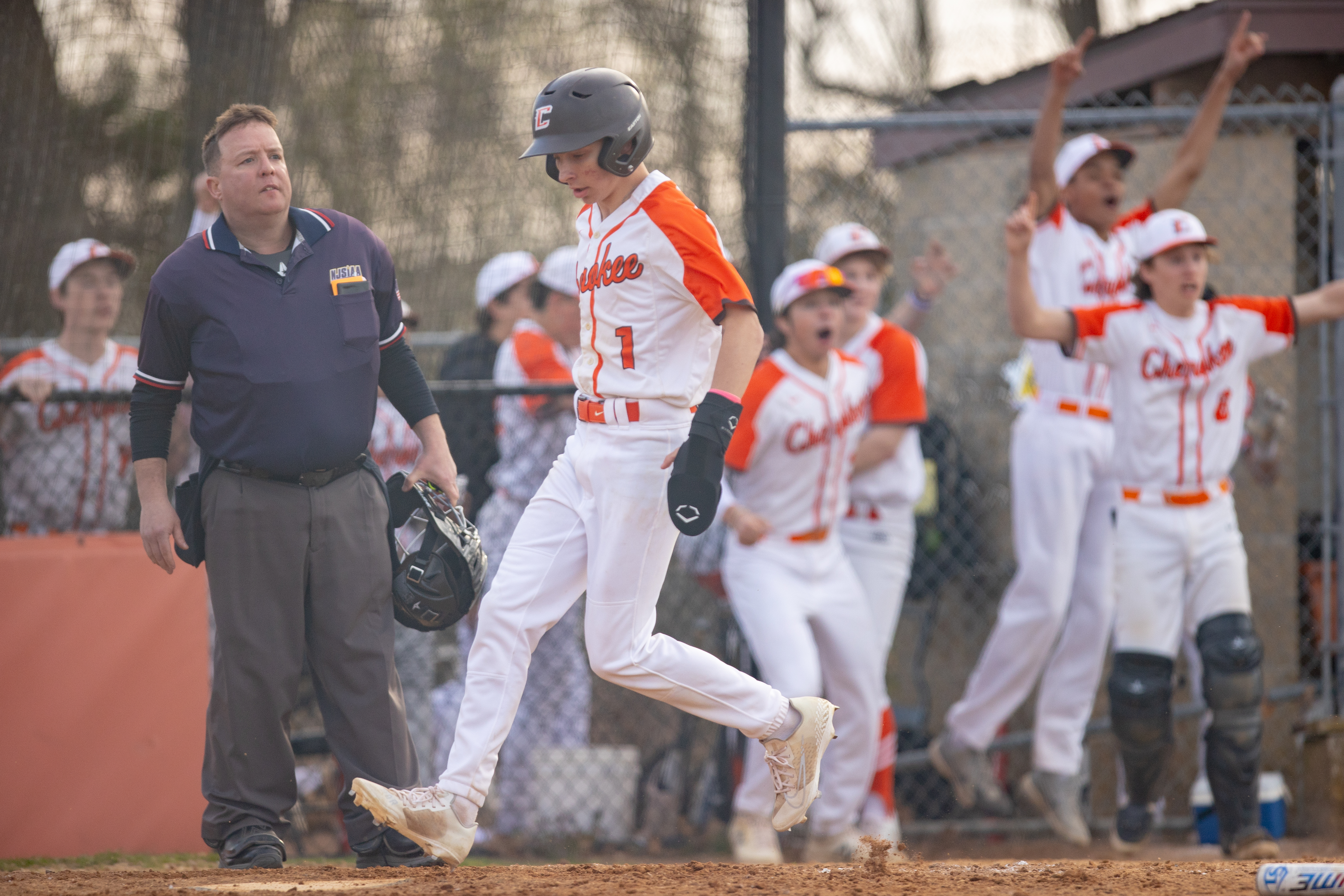Jack White (1) of Cherokee, comes in to score off a grand slam home run by Danny Torres (33), in Marlton, NJ on Monday, April 3, 2023.