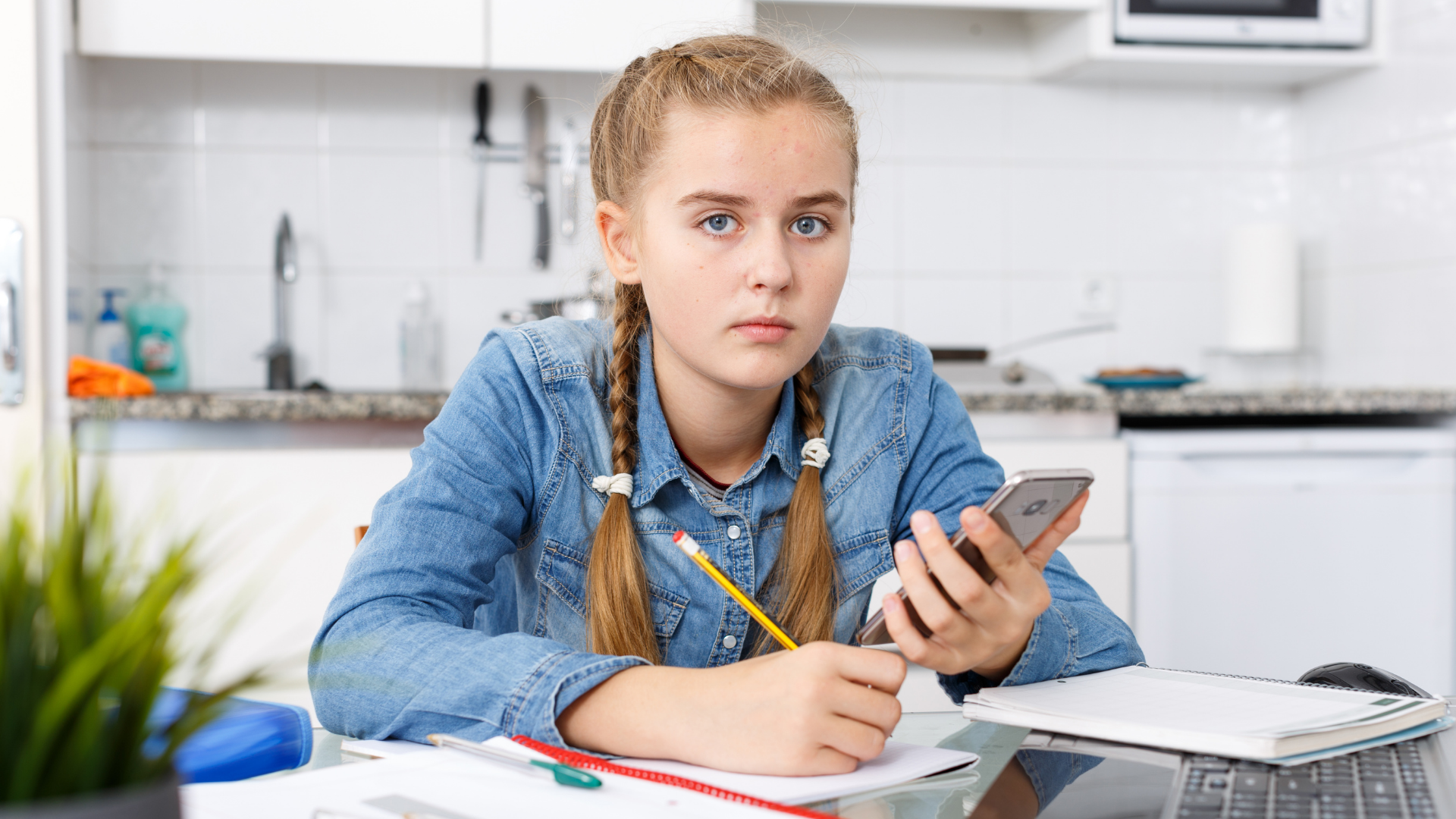 После школы дома. Doing homework using cellphone. Photo the girl is doing her homework.