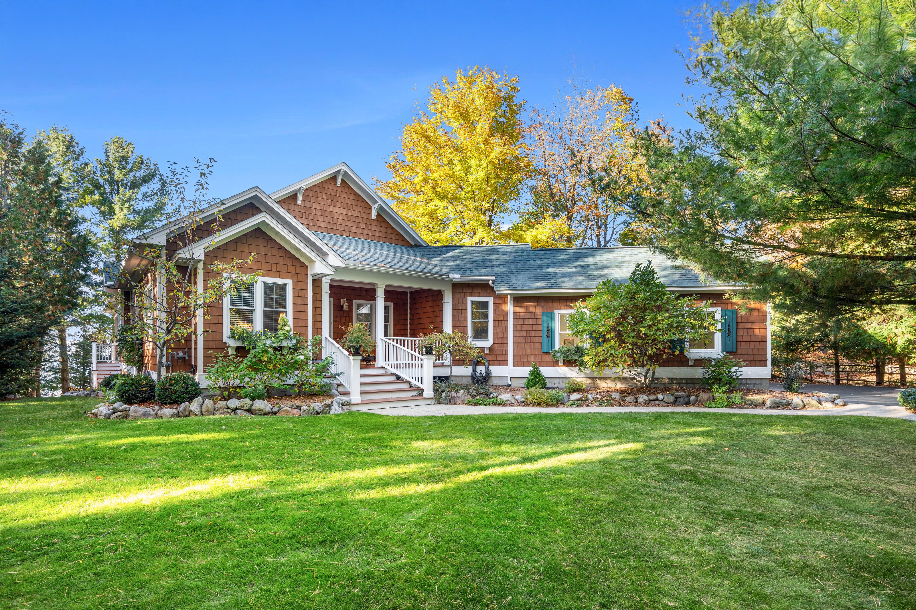 Exterior photographs of 4093 Lake Shore Drive in Charlevoix, this gem is listed at $2,099,900 through Berkshire Hathaway HomeServices Michigan Real Estate – Traverse City and The Crane Group with associate broker Johnny Crane and his brother, co-listing agent Matt Crane.