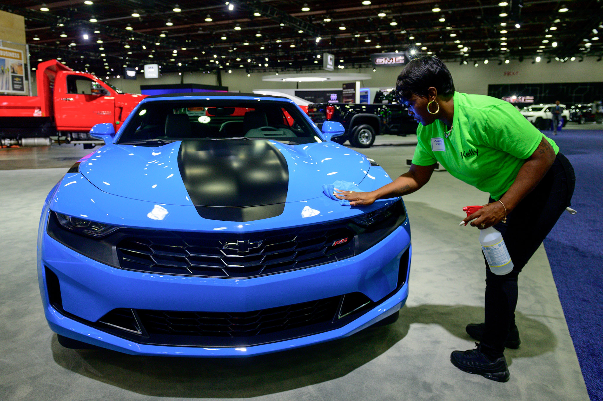 An employee wipes prints off a Chevrolet Camaro as the 2022 North American International Auto Show begins with media preview day at Huntington Place in Detroit on Wednesday, Sept. 14 2022.