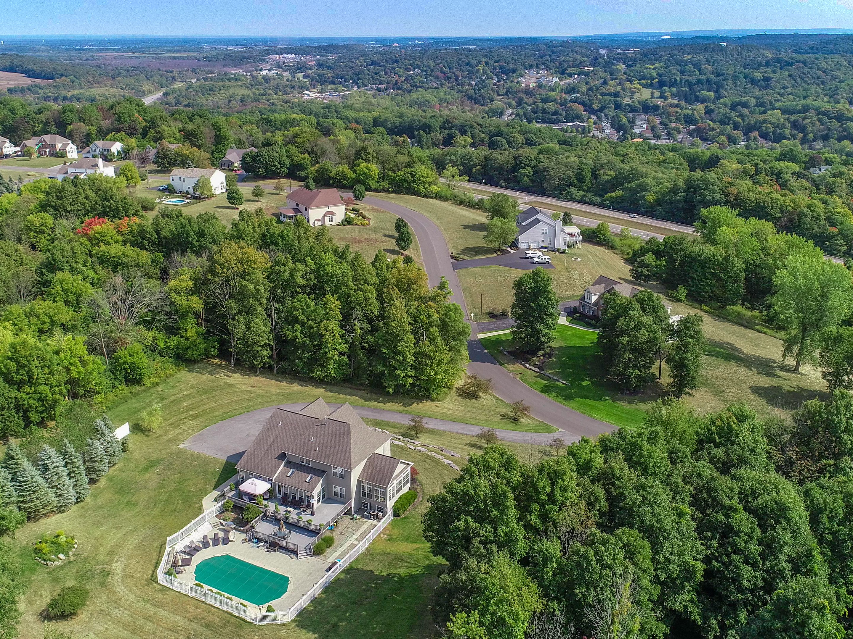 Brick Camillus home sits atop a hill overlooking six acres
