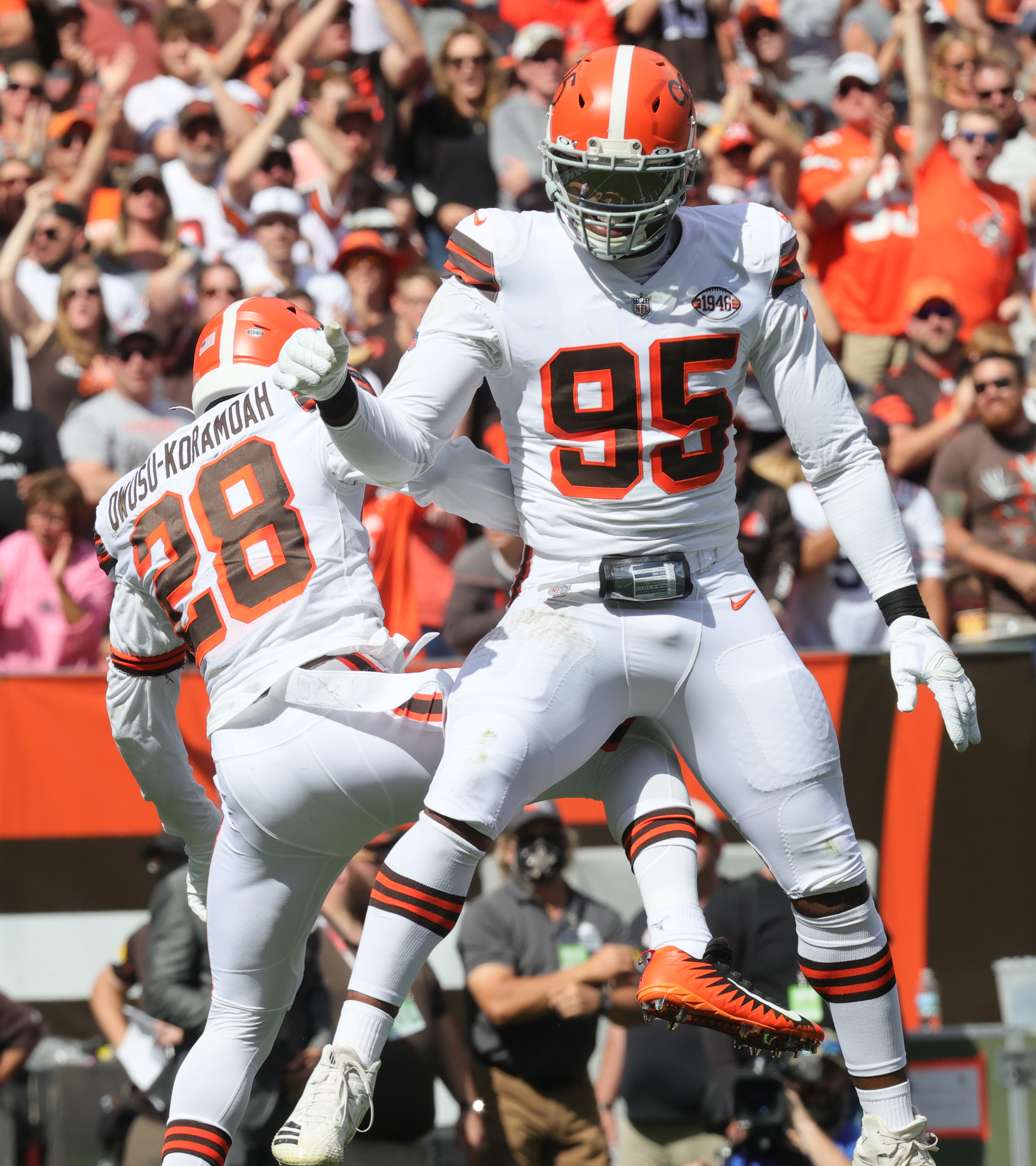 Cleveland Browns linebacker Jeremiah Owusu-Koramoah (28) and defensive end  Myles Garrett (95) celebrate during an NFL football game against the  Chicago Bears, Sunday, Sept. 26, 2021, in Cleveland. The Browns won 26-6. (