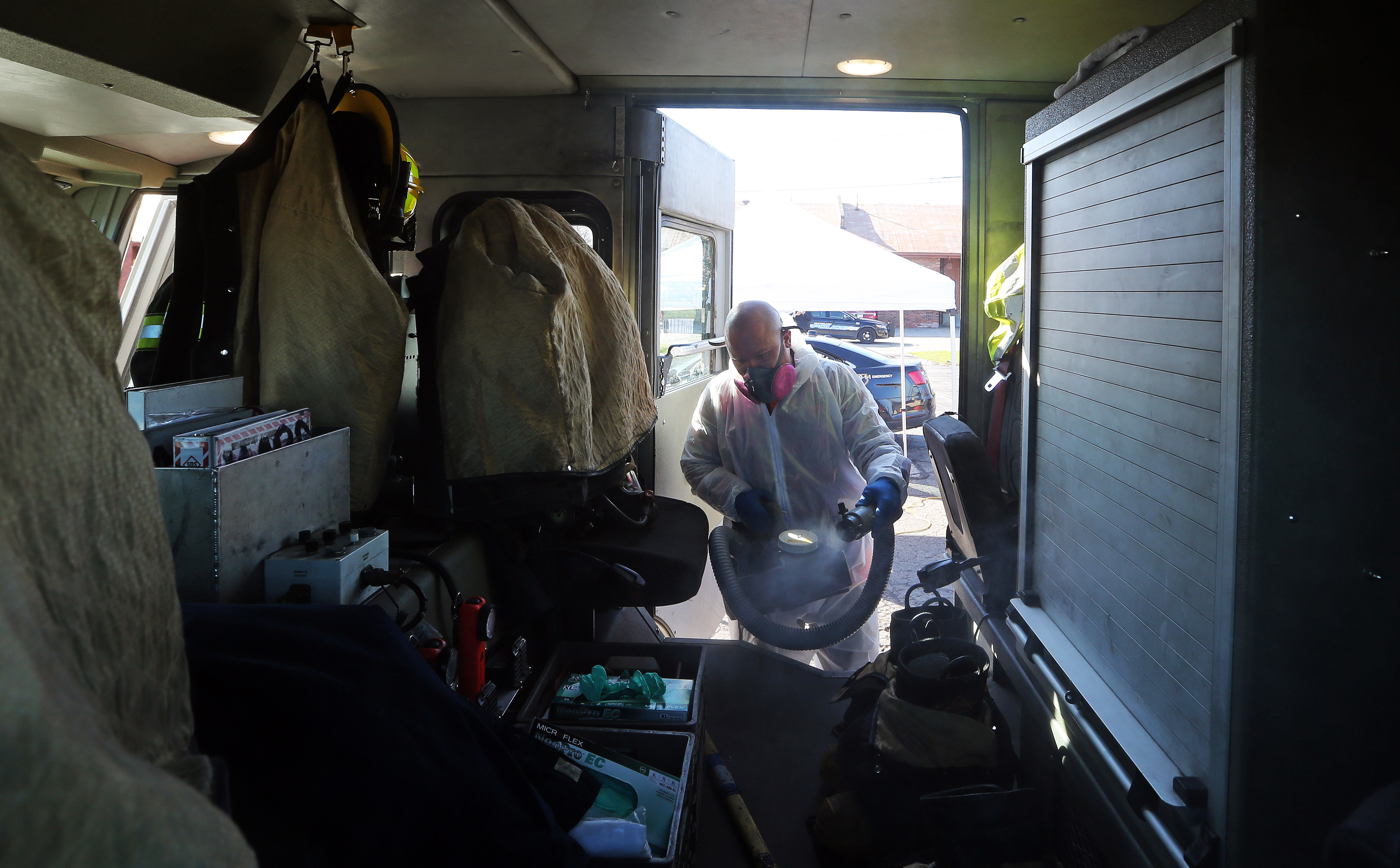 Josh Wojciechowski, of Emergency Clean Team, sanitizes public safety vehicles