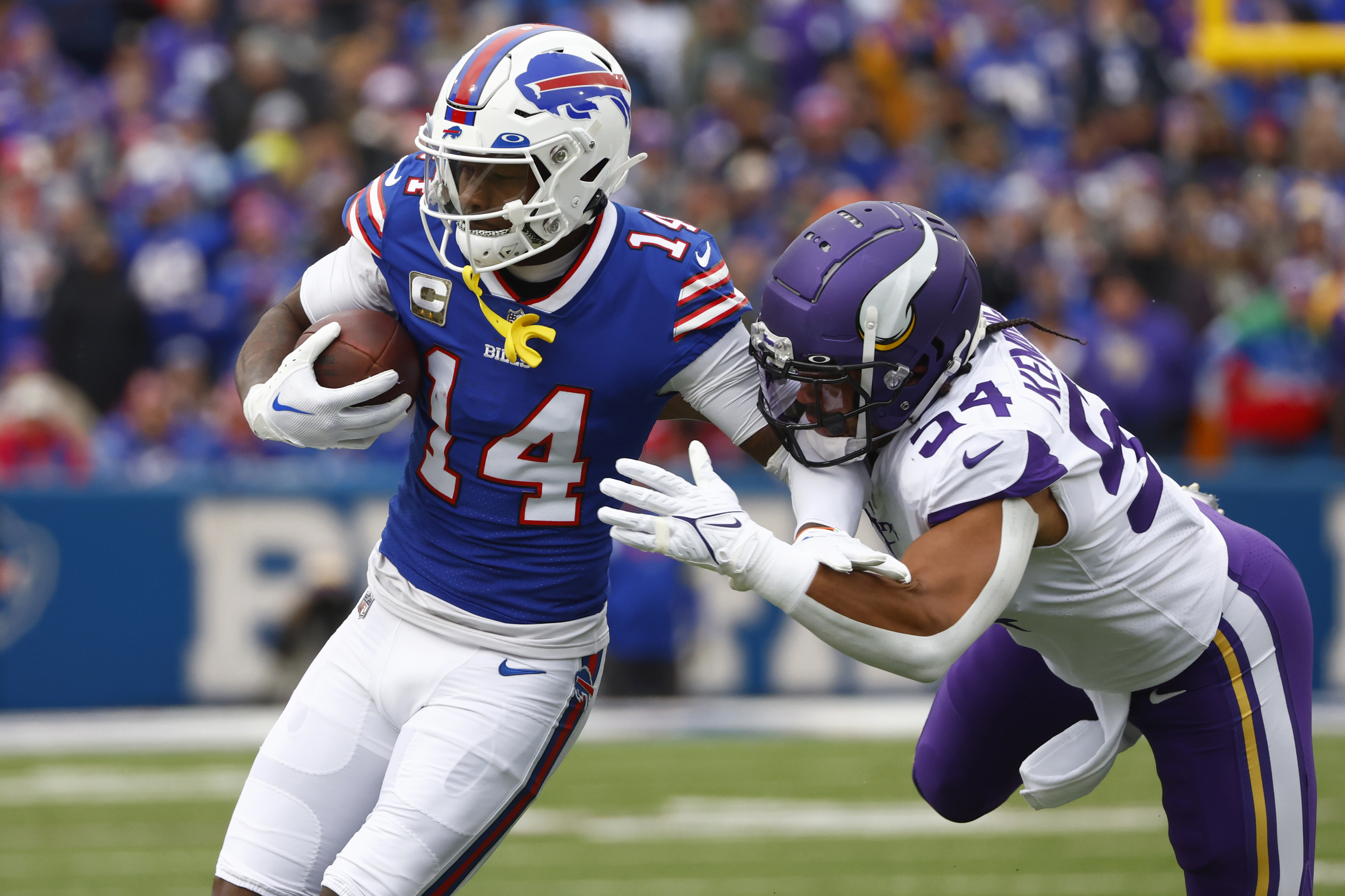 Buffalo Bills wide receiver Stefon Diggs tries to evade Minnesota Vikings  cornerback Andrew Booth Jr. (23) in the second half of an NFL football game,  Sunday, Nov. 13, 2022, in Orchard Park