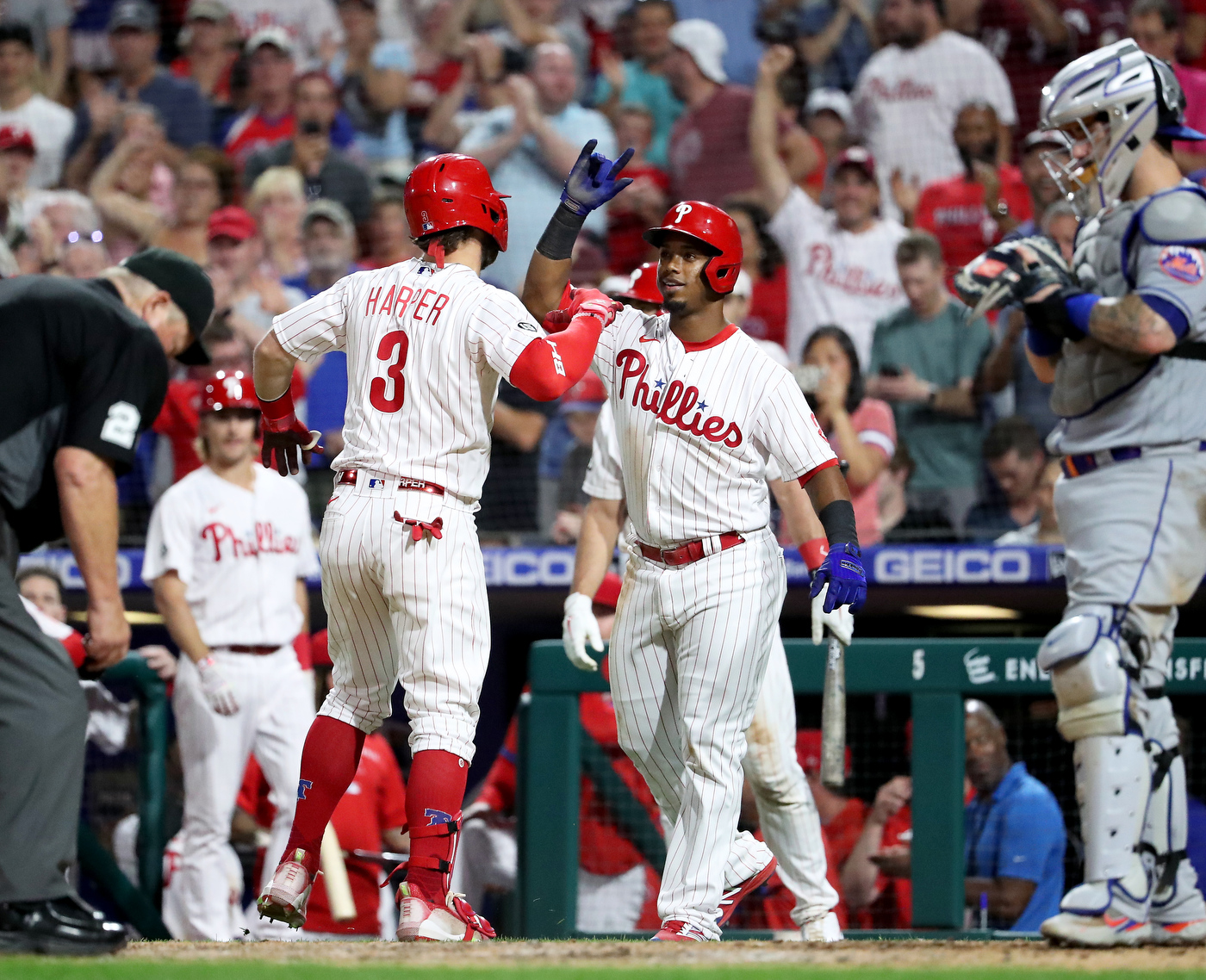 Bryce Harper and Jean Segura of the Philadelphia Phillies react