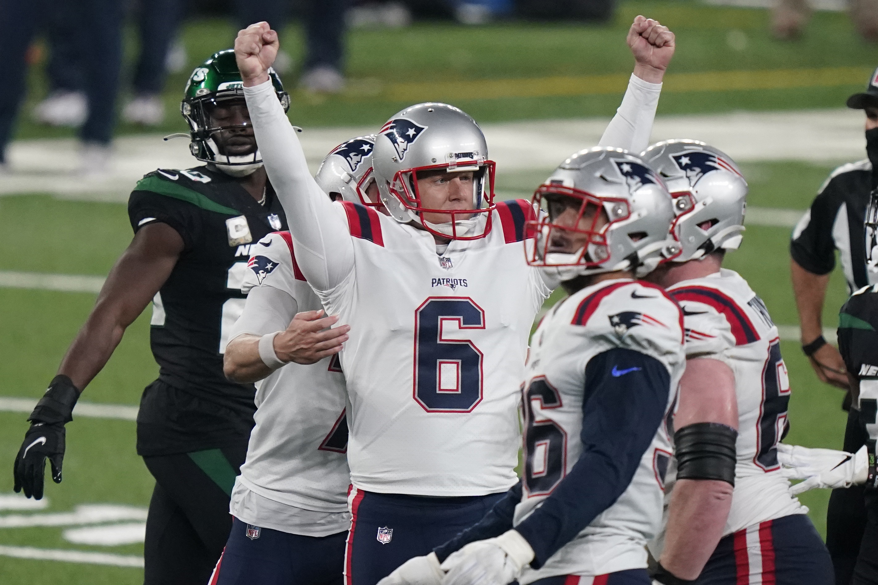 New England Patriots defensive end Lawrence Guy, left, and Isaiah Wynn  celebrate after teammate Nick Folk kicked a field goal during the second  half of an NFL football game against the Buffalo