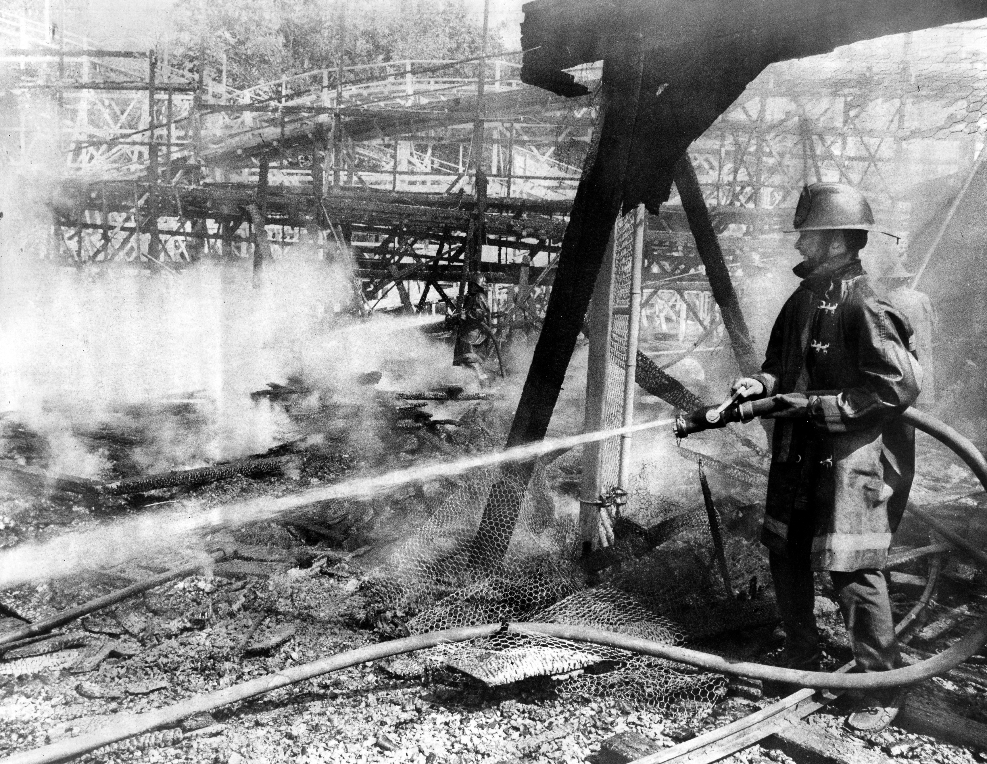 Sept. 1, 1971 - Agawam - An Agawam firefighter pours water on the remnants of the El Dorado Mine Train Ride at Riverside Park. The fire destroyed the ride and put the adjacent roller coaster out of commission. (Republican file photo) Staff-Shot