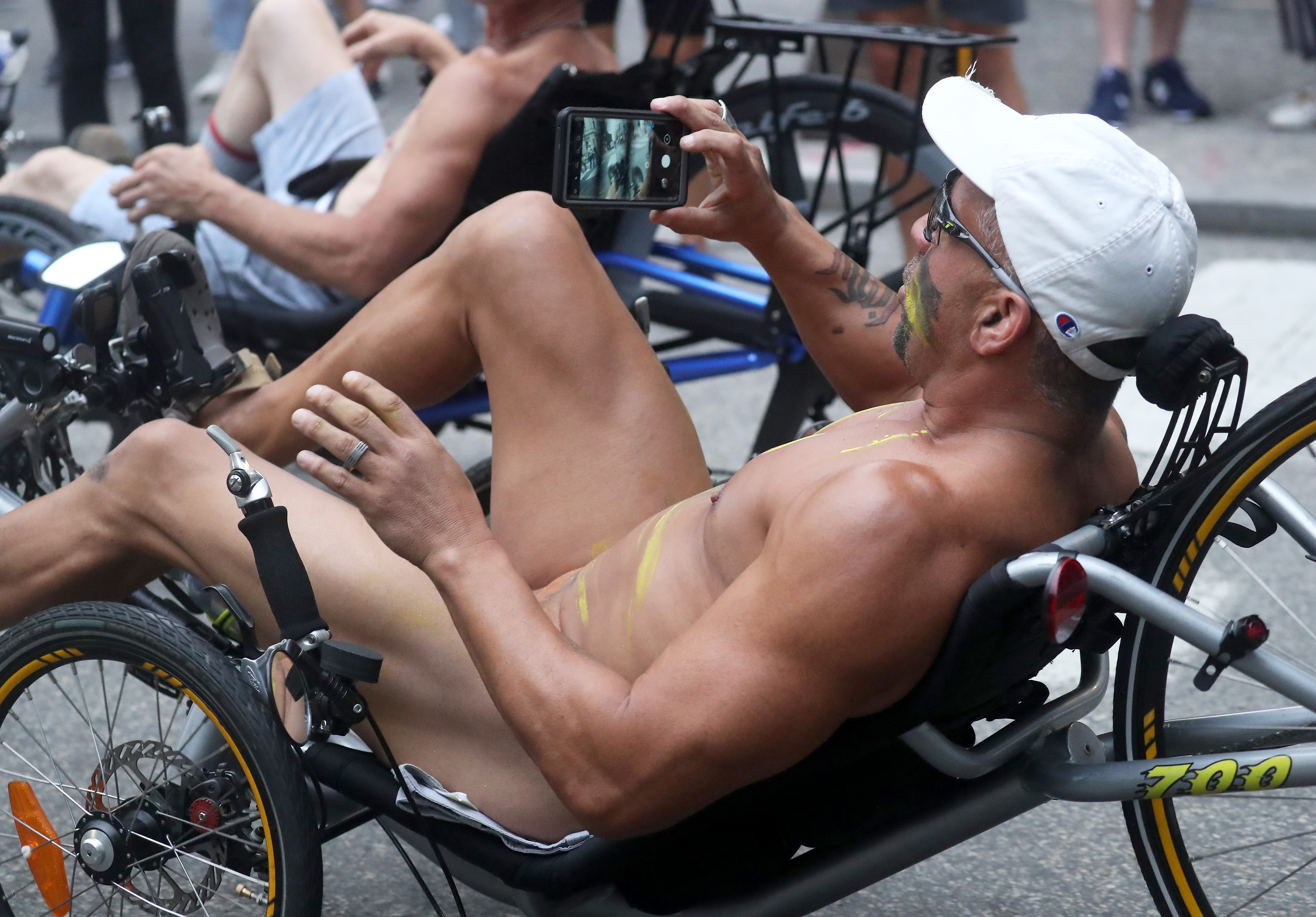 People ride bikes around Rittenhouse Square in Philadelphia during the Philly Naked Bike Ride, Saturday, Aug. 28, 2021.