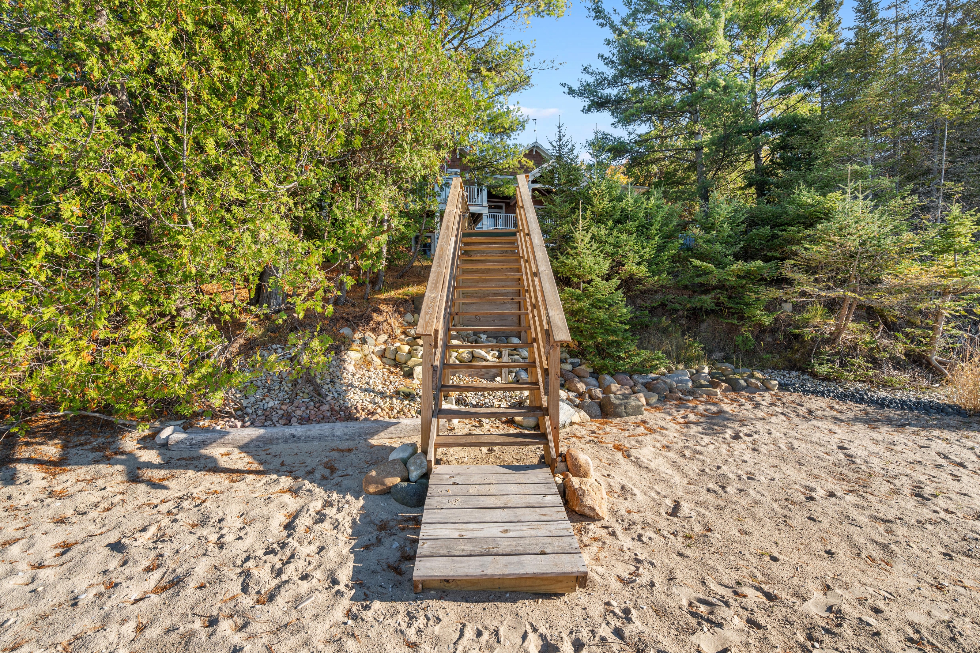 Exterior photographs of 4093 Lake Shore Drive in Charlevoix, this gem is listed at $2,099,900 through Berkshire Hathaway HomeServices Michigan Real Estate – Traverse City and The Crane Group with associate broker Johnny Crane and his brother, co-listing agent Matt Crane.