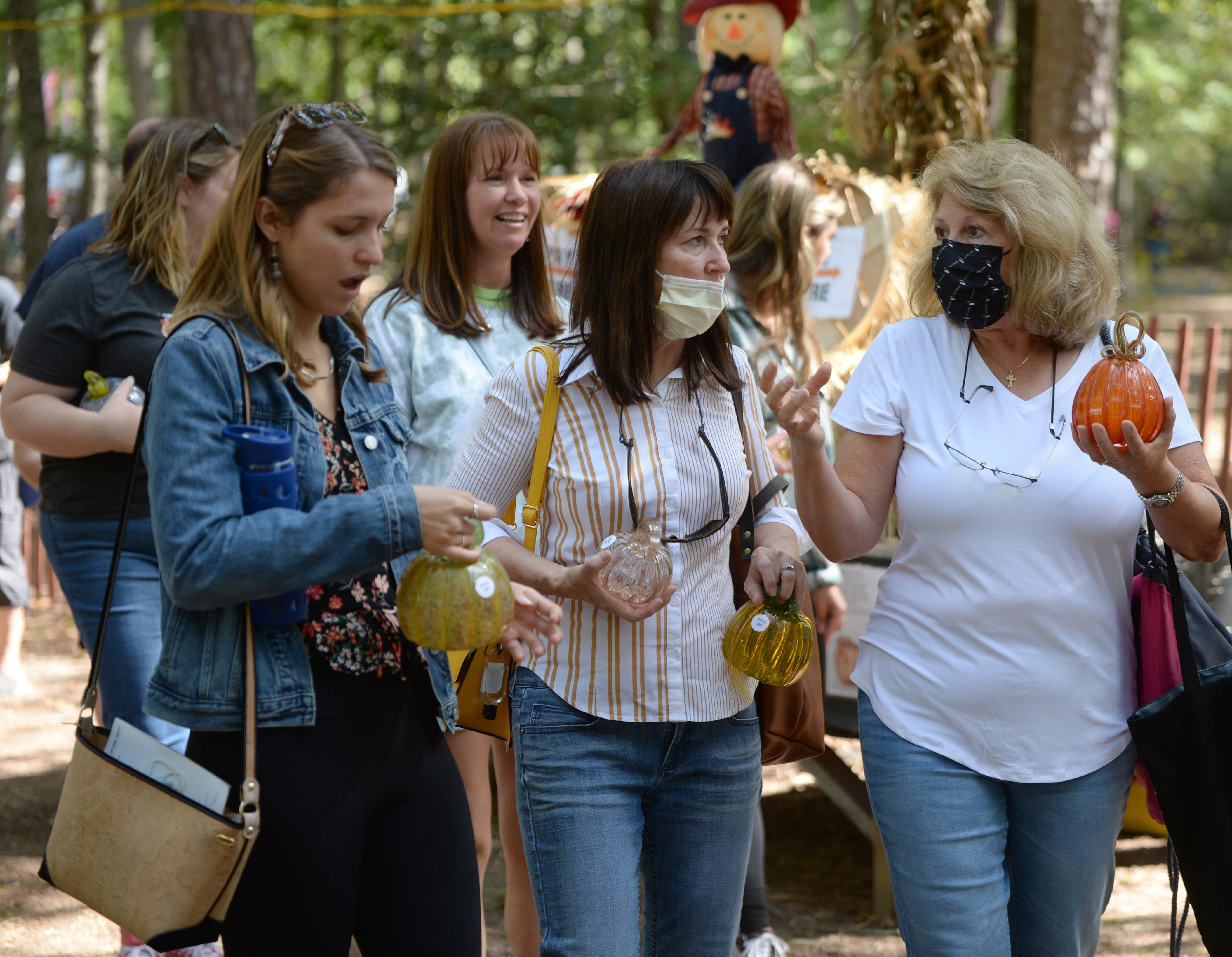 Customers wait in long lines to purchase limited edition handcrafted glass pumpkins during the 22nd annual Festival of Fine Craft at Wheaton Arts in Millville, Saturday, Oct. 2, 2021.
