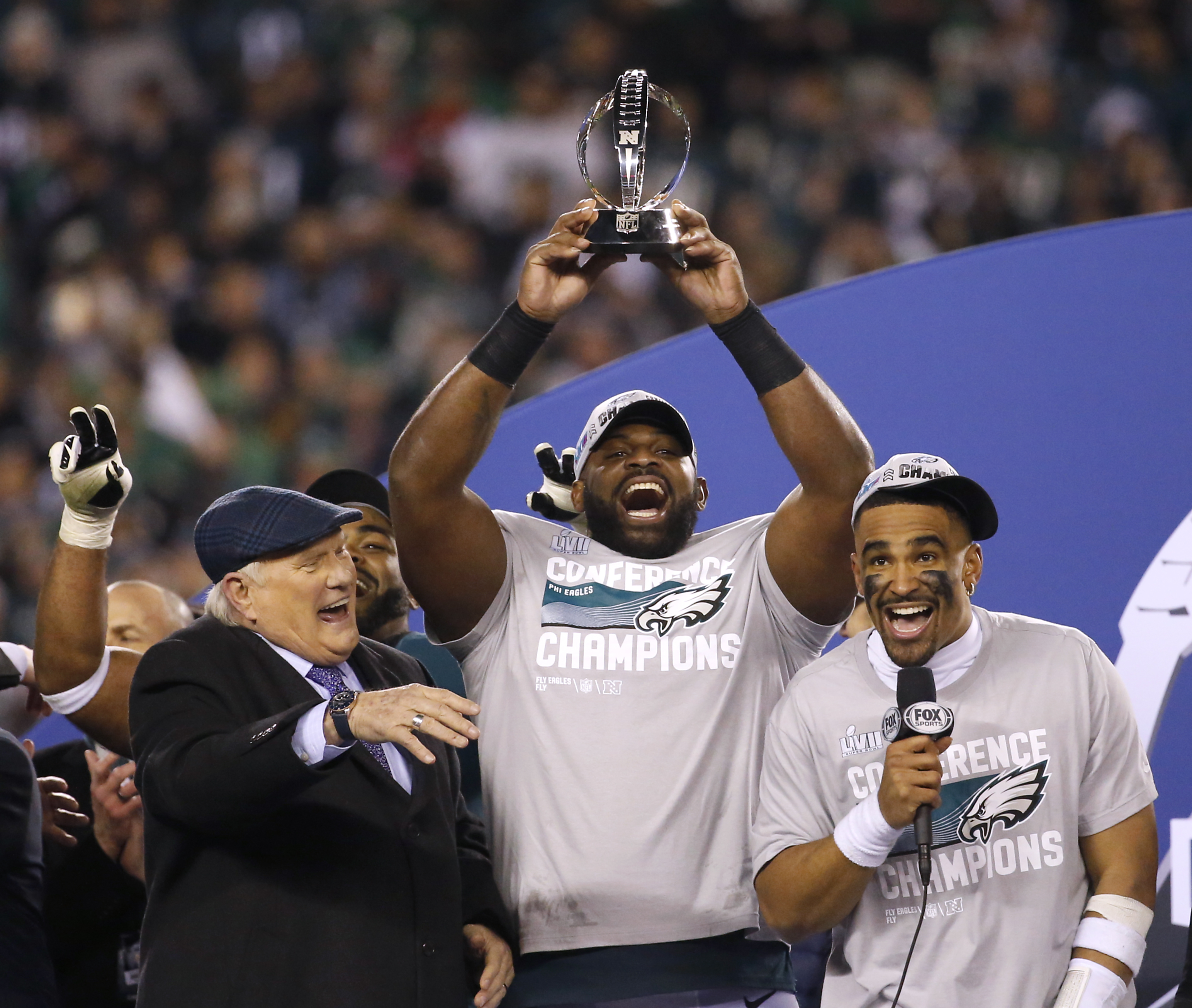 Jalen Hurts of the Philadelphia Eagles holds the George Halas