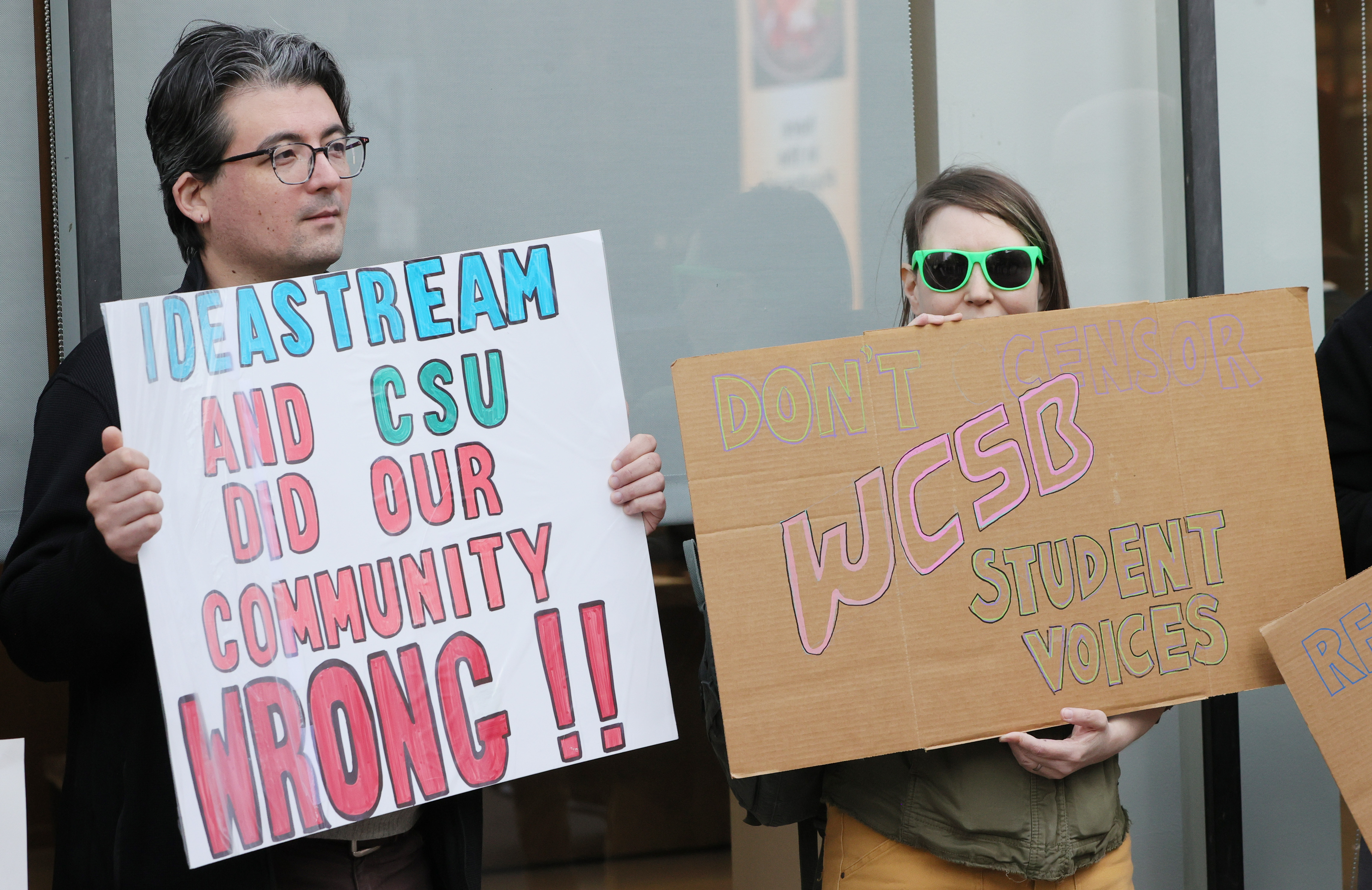 Protestors rally outside Cleveland’s City Club during lunch forum with ...