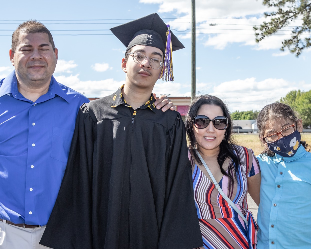 Tommy Martes and family pose for a photo at the Veritas Prep Charter School 8th grade 2020 DRIVE-In Graduation held in the parking lot of the Eastfield Mall. (Danny Nason Photo)