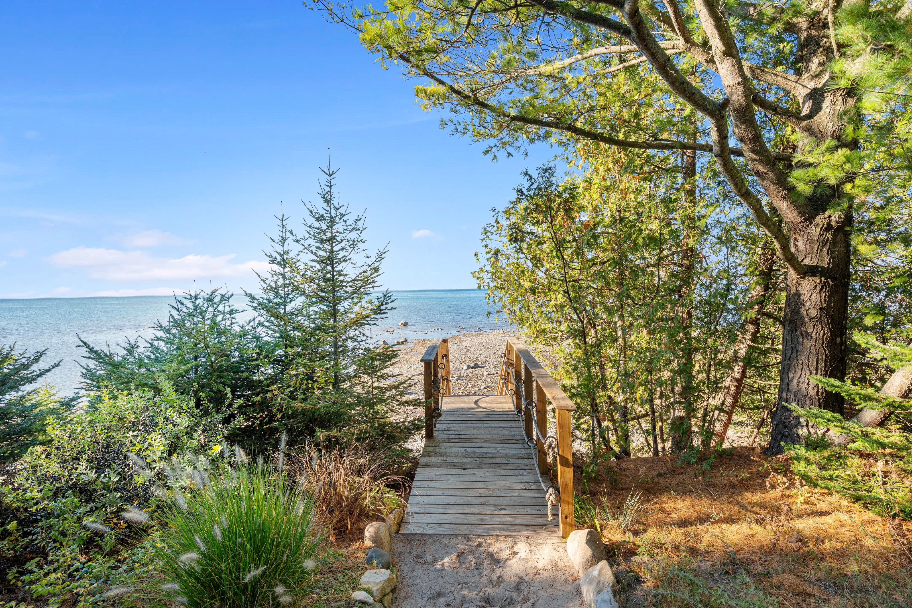Exterior photographs of 4093 Lake Shore Drive in Charlevoix, this gem is listed at $2,099,900 through Berkshire Hathaway HomeServices Michigan Real Estate – Traverse City and The Crane Group with associate broker Johnny Crane and his brother, co-listing agent Matt Crane.