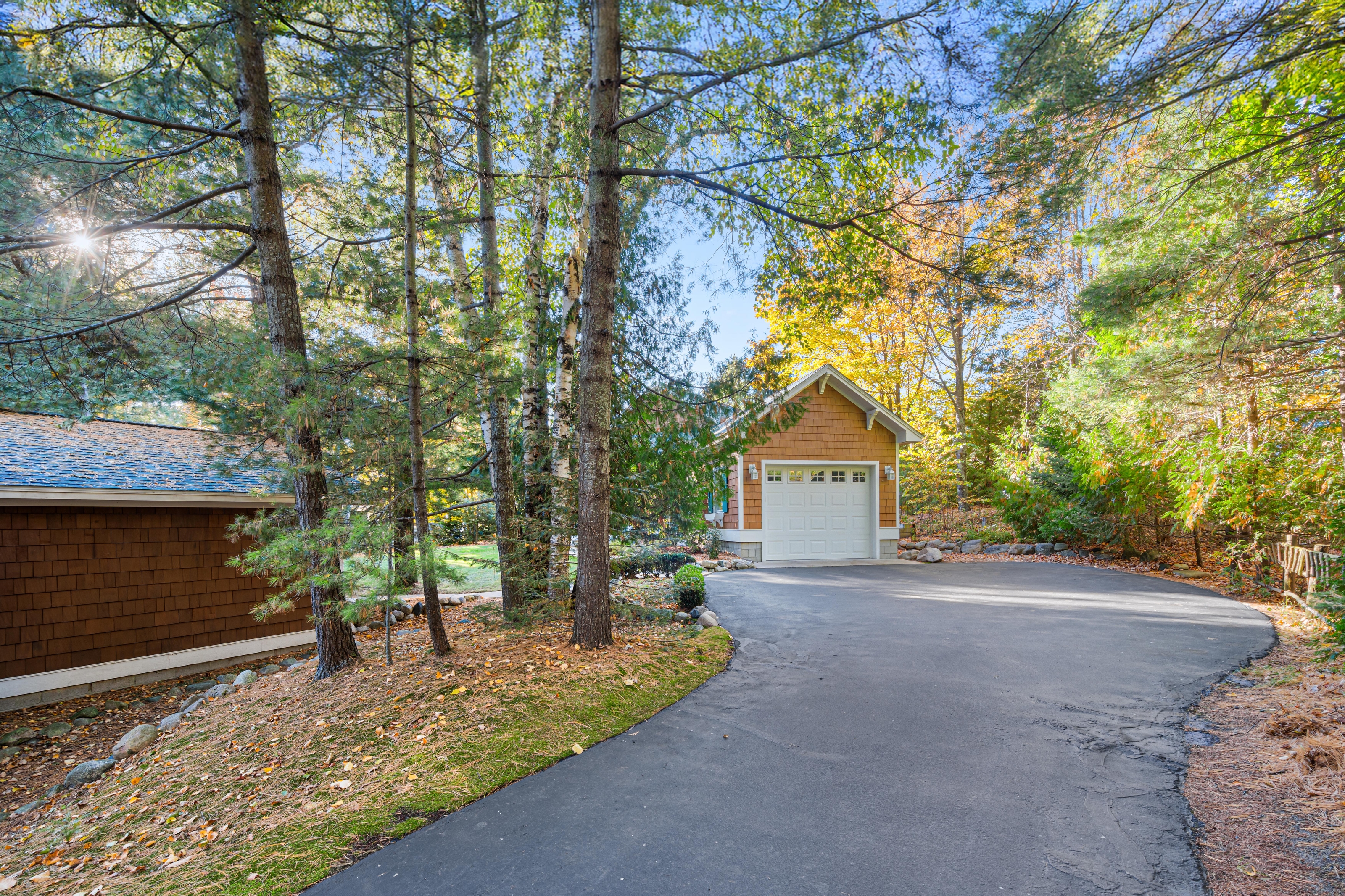 Exterior photographs of 4093 Lake Shore Drive in Charlevoix, this gem is listed at $2,099,900 through Berkshire Hathaway HomeServices Michigan Real Estate – Traverse City and The Crane Group with associate broker Johnny Crane and his brother, co-listing agent Matt Crane.