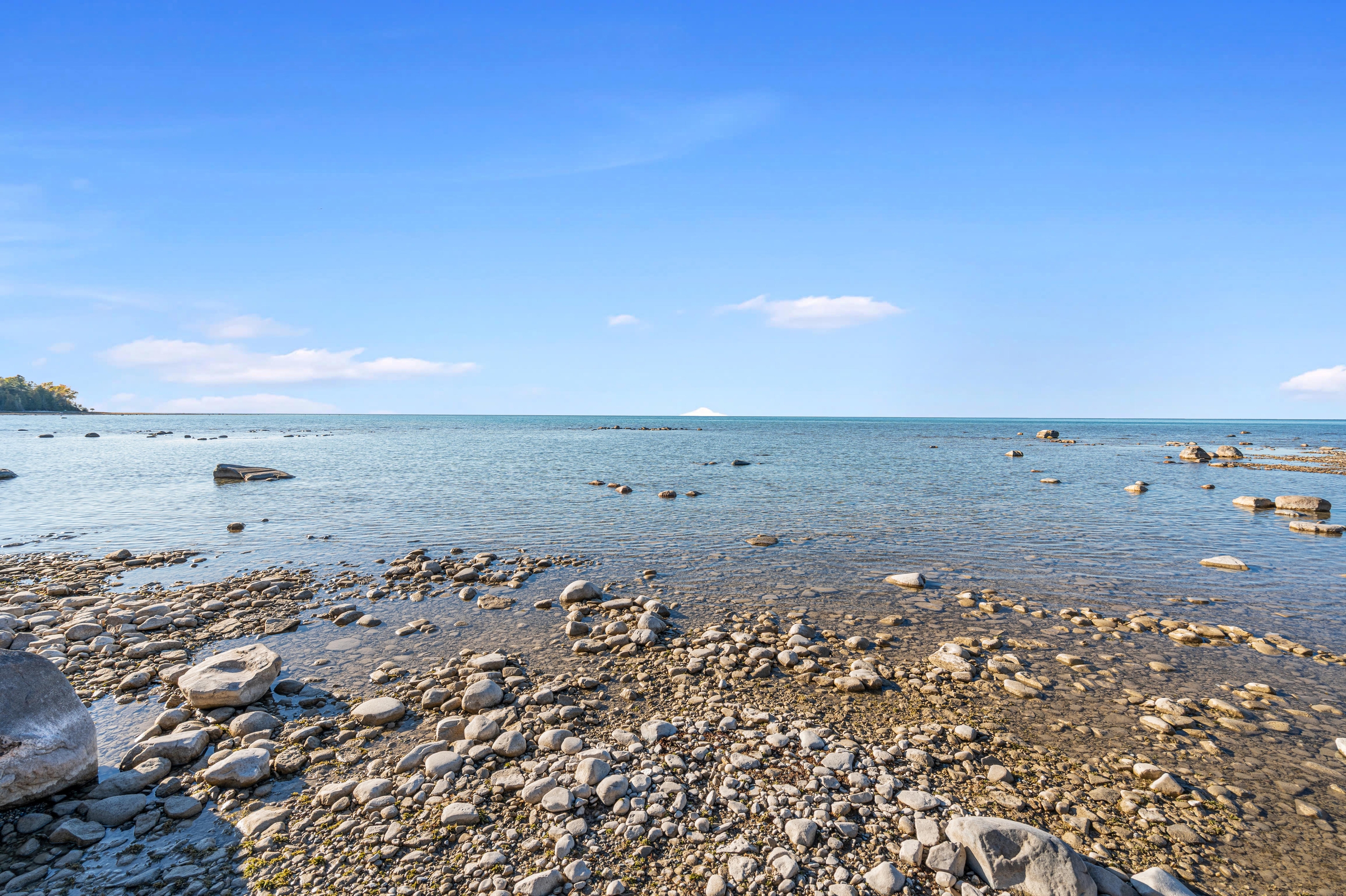 Exterior photographs of 4093 Lake Shore Drive in Charlevoix, this gem is listed at $2,099,900 through Berkshire Hathaway HomeServices Michigan Real Estate – Traverse City and The Crane Group with associate broker Johnny Crane and his brother, co-listing agent Matt Crane.