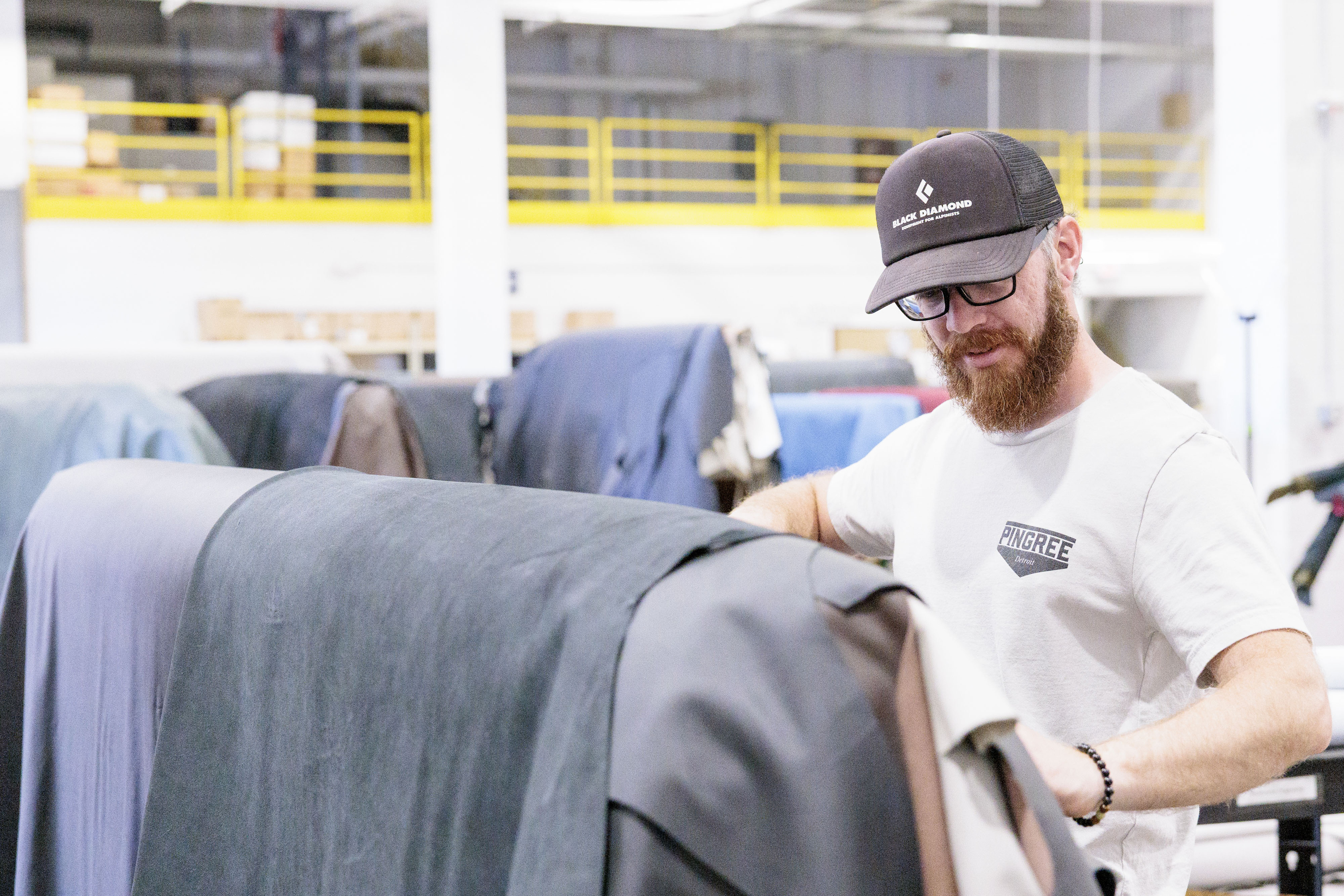 Pingree Detroit’s Brandon Kulow sorts through donated automotive leather at Pangea in Rochester Hills on Monday, Oct. 6 2025.