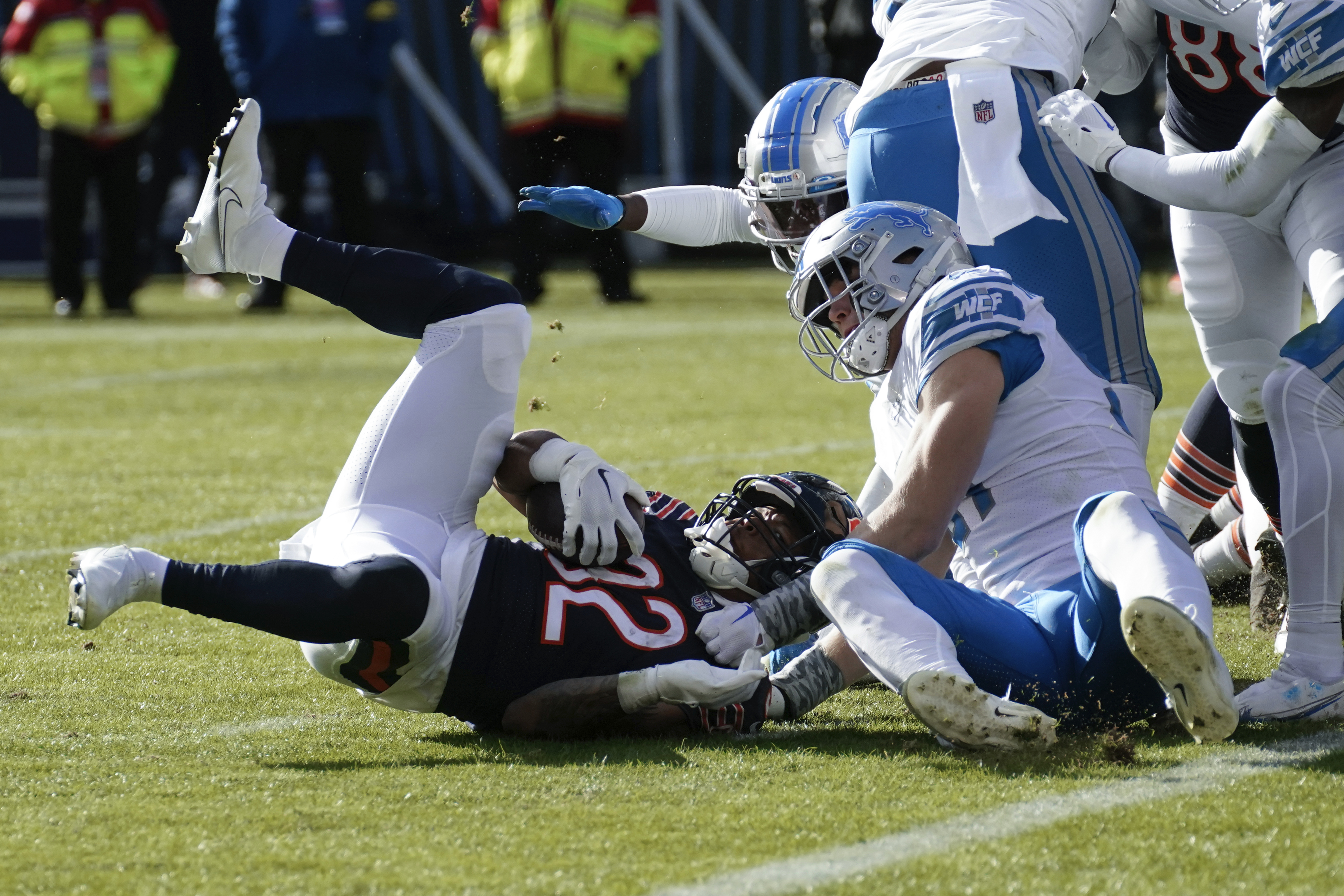 Detroit Lions running back D'Andre Swift (32) is brought down by Chicago  Bears linebacker Nicholas Morrow (53) during the first half of an NFL  football game in Chicago, Sunday, Nov. 13, 2022. (