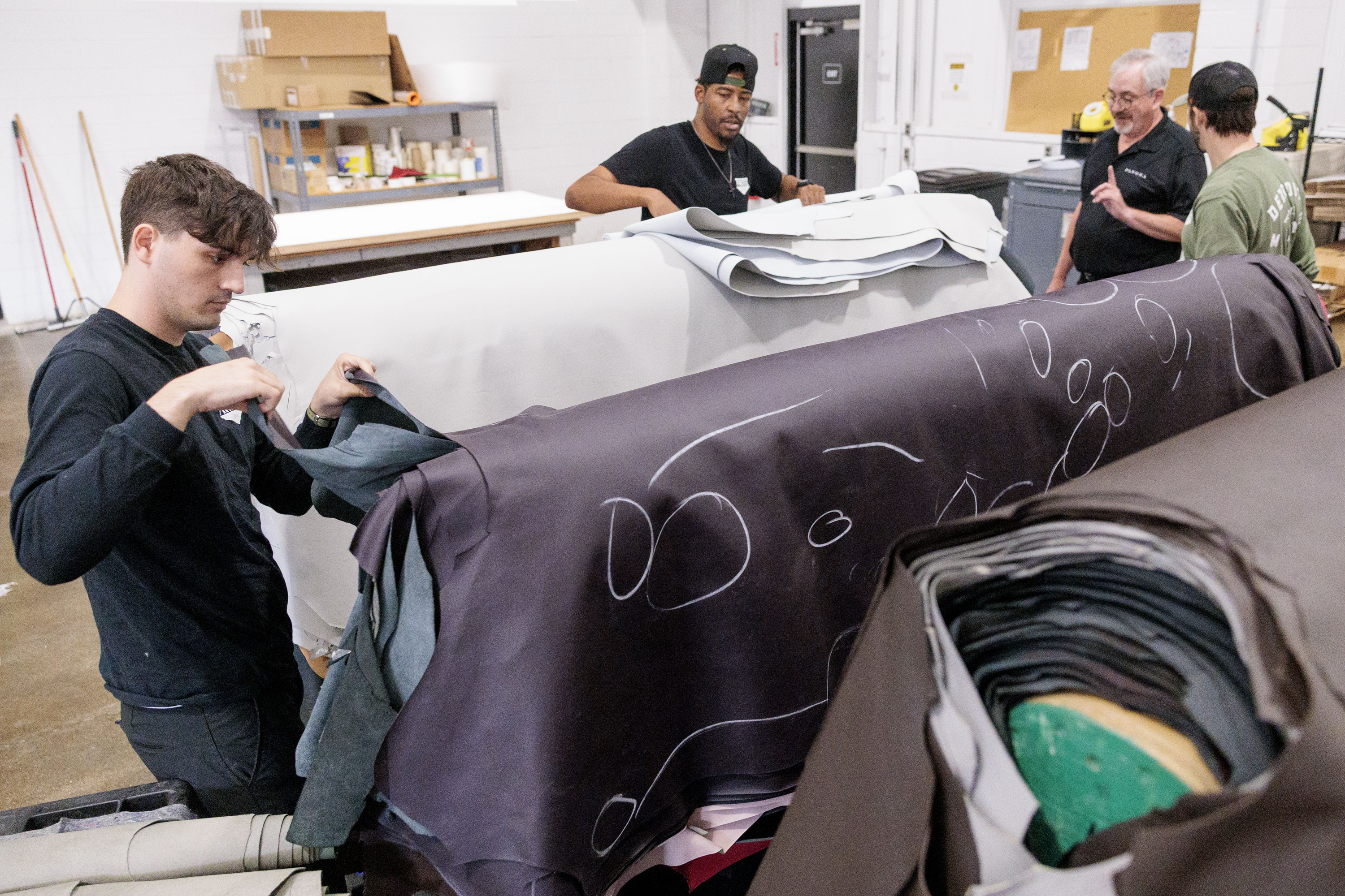 Pingree Detroit employees, including Eric Rranxburgaj, left, sort through donated leather hides at Pangea in Rochester Hills on Monday, Oct. 6 2025.