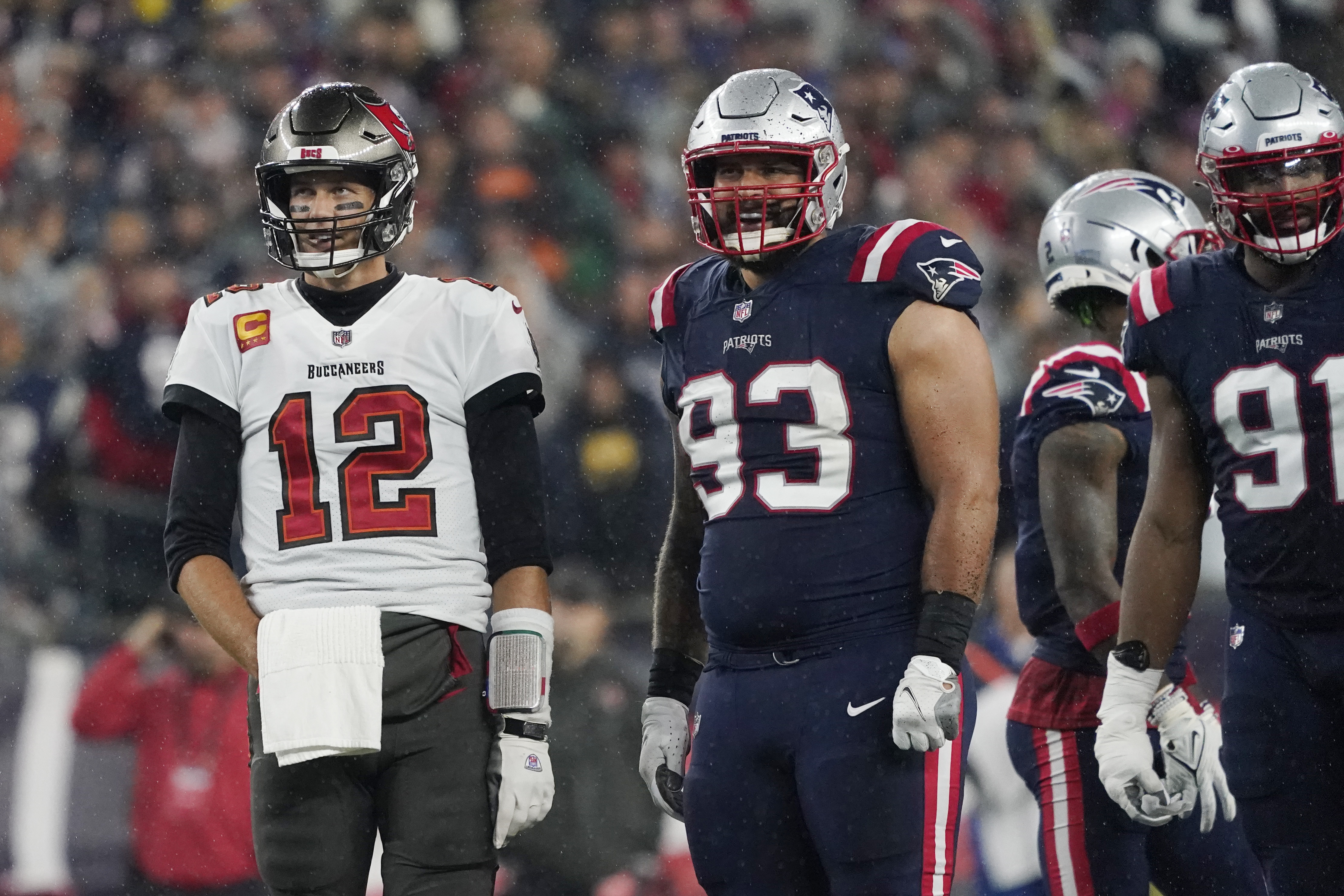 Tampa Bay Buccaneers quarterback Tom Brady (12) meets with New England  Patriots long snapper Jo …