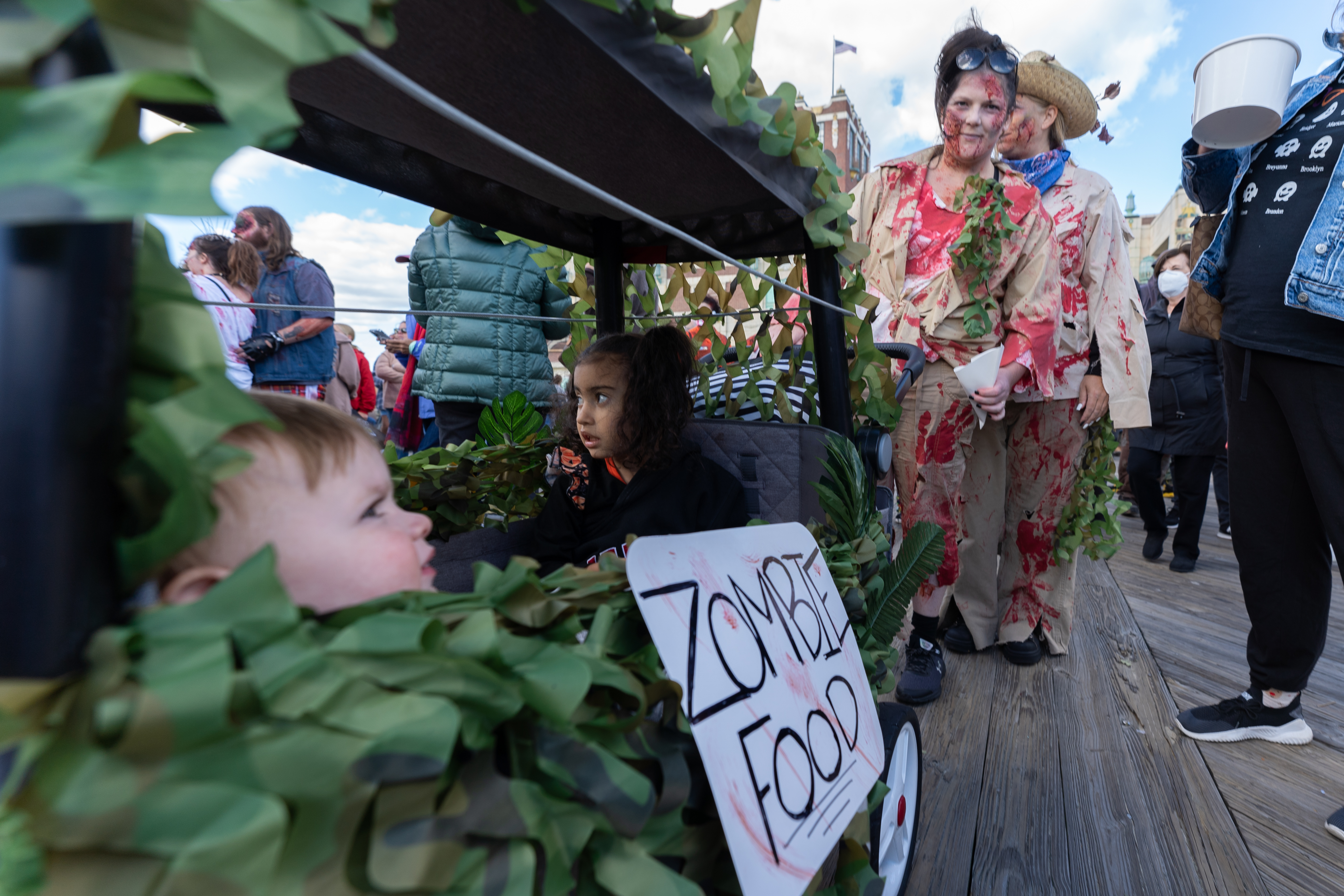Two zombies push a cart of "zombie food" along the boardwalk during the 14th Asbury Park Zombie Walk in Asbury Park on Saturday, October 8, 2022. The zombie walk held its first themed year with the theme being 80's and 90's punk and metal.