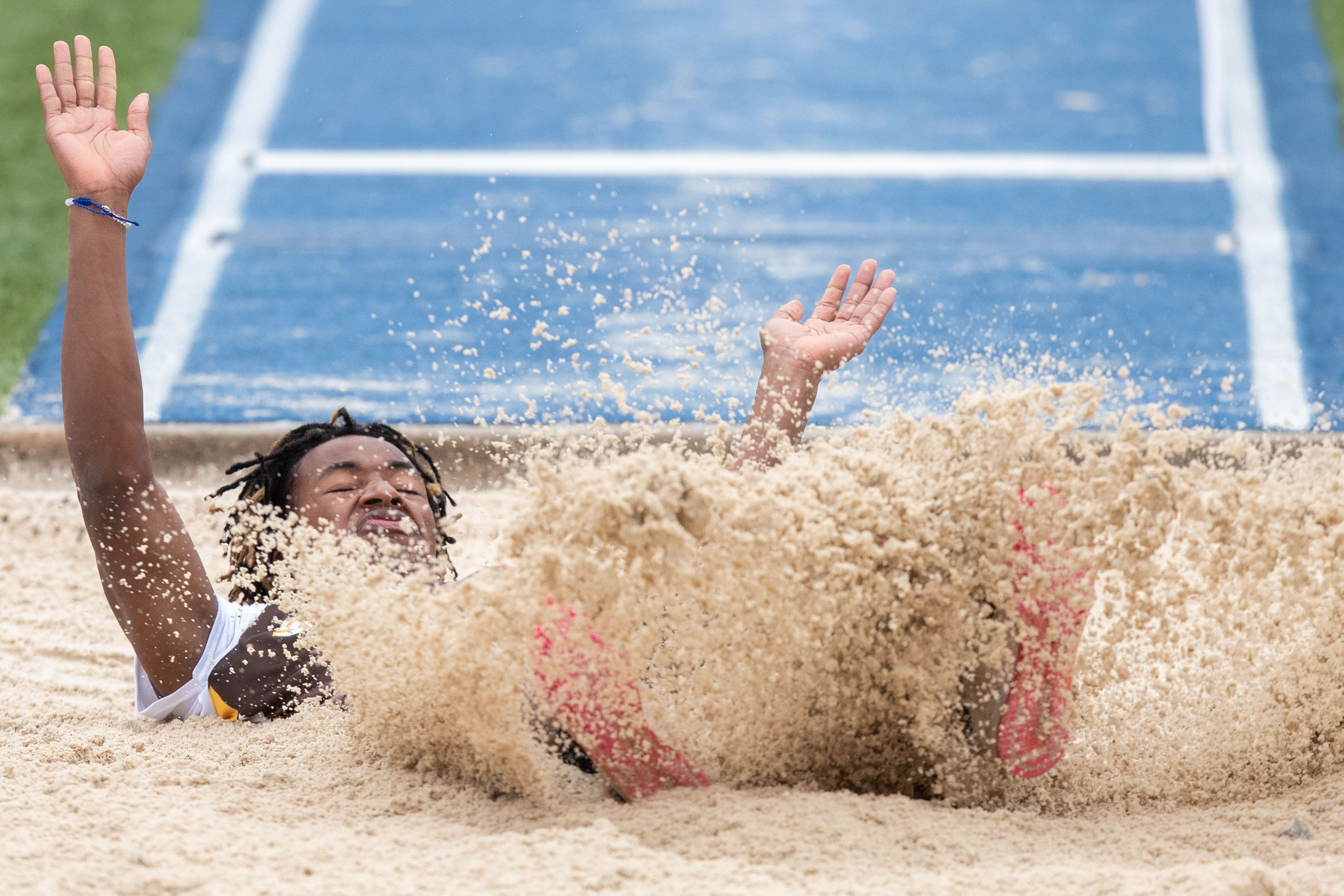 Michael Blidi, Milton Hershey, lands in the triple jump pit at the 2023 Tim Cook Memorial Invitational track & field meet at Chambersburg, Pa., Mar. 25, 2023.Mark Pynes | pennlive.com