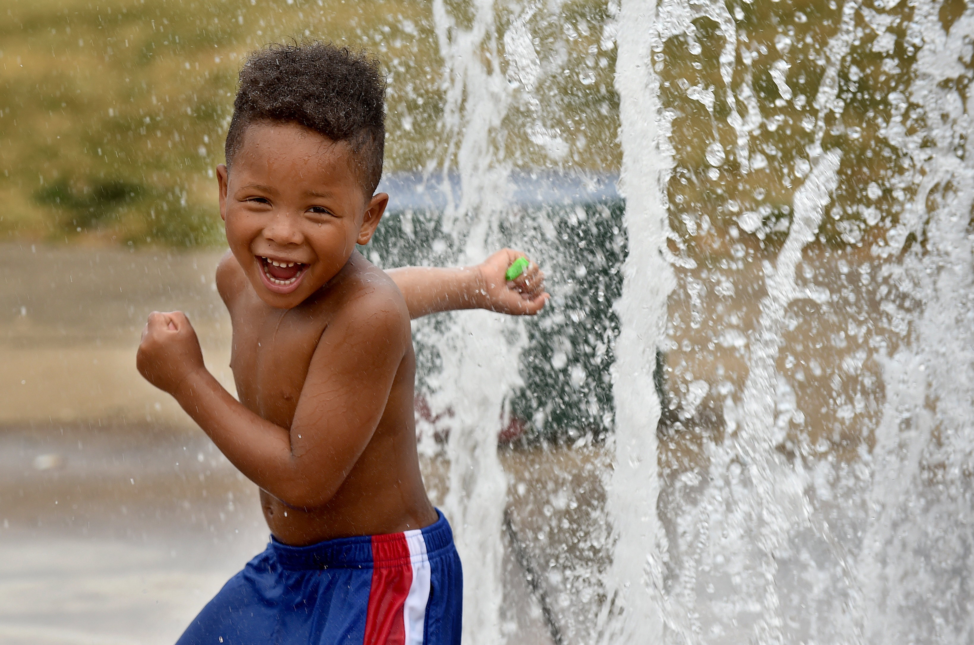 People are still looking for a way to cool down during a heat spell in Syracuse, July 8, 2020. These kids head to the spray area at Union Park on the city's north side. Laythaniel DeJesus 4 runs through a fountain without getting his face wet.  Dennis Nett | dnett@syracuse.com