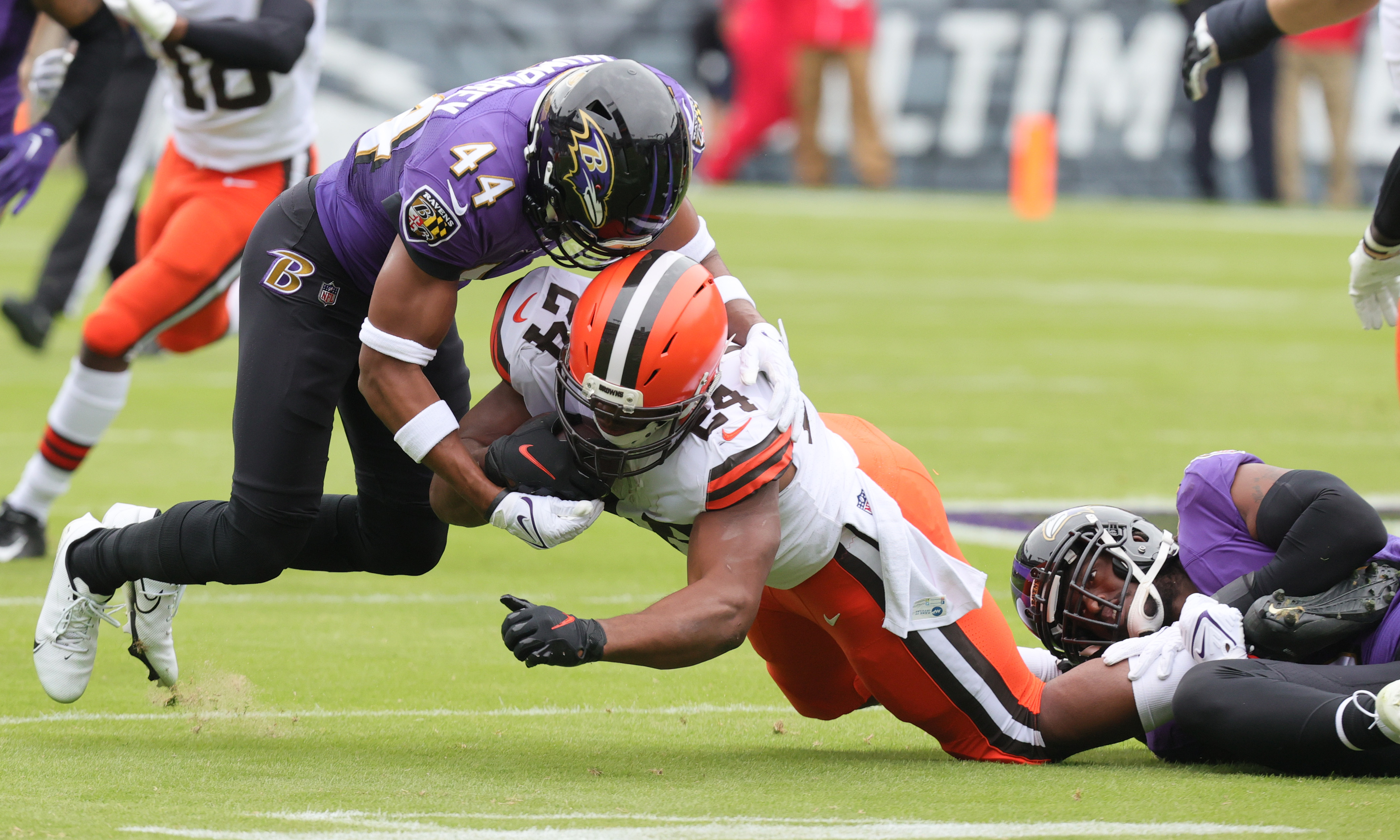 Baltimore Ravens safety Chuck Clark (36) and cornerback Marlon Humphrey (44)  miss a tackle of C …