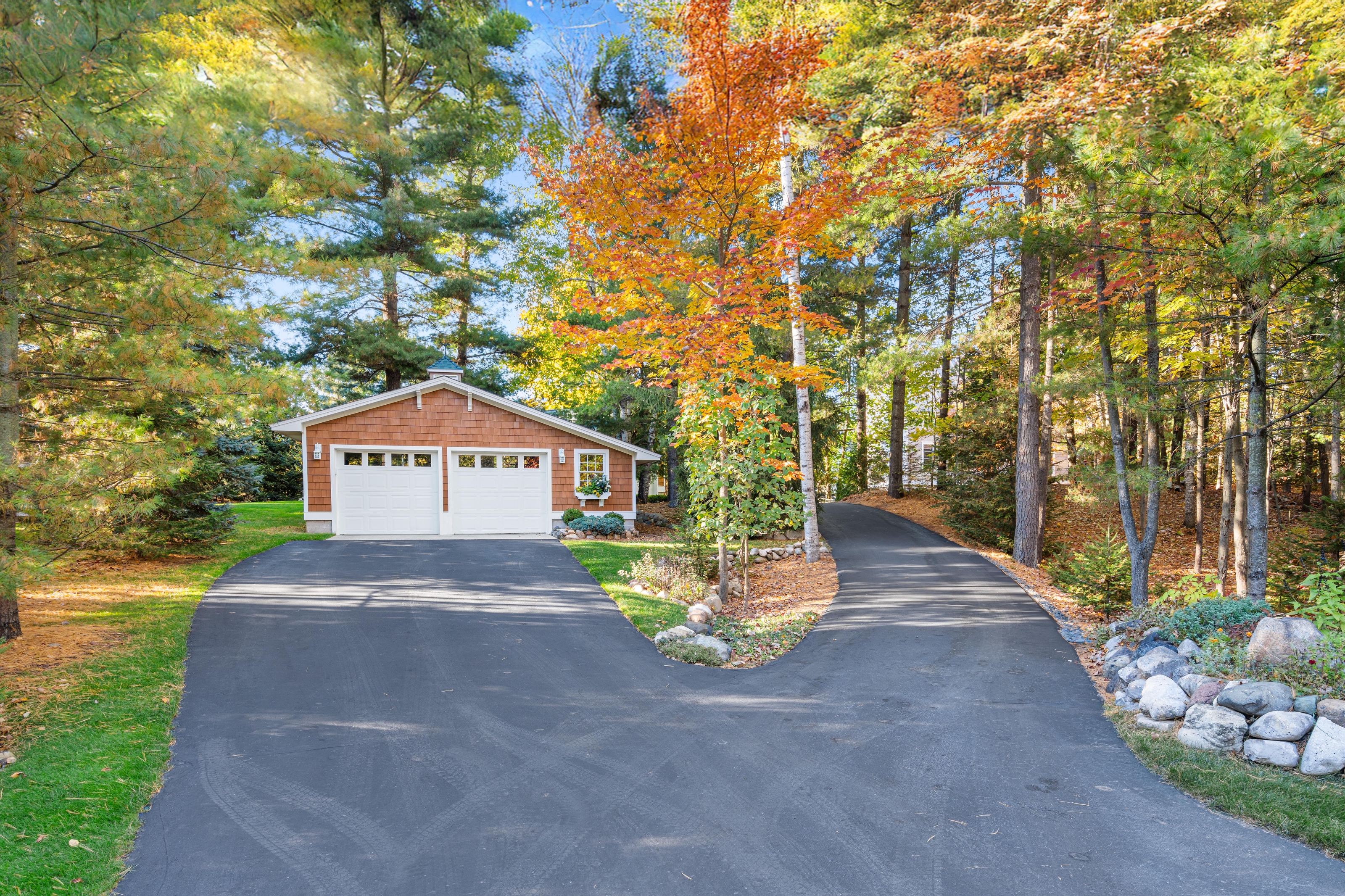 Exterior photographs of 4093 Lake Shore Drive in Charlevoix, this gem is listed at $2,099,900 through Berkshire Hathaway HomeServices Michigan Real Estate – Traverse City and The Crane Group with associate broker Johnny Crane and his brother, co-listing agent Matt Crane.