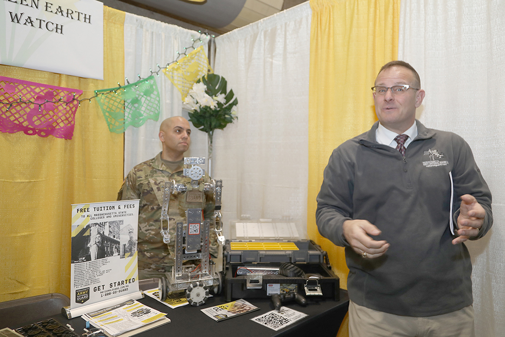 L to R- Eddy Ortiz and Geoff Allen from the National Guard from their Citizen Earth Watch table spoke to students abut robotics at the Sustainathon event taking place in the gym in building 2 at Springfield Technical Community College on April 11th. (Ed Cohen Photo)