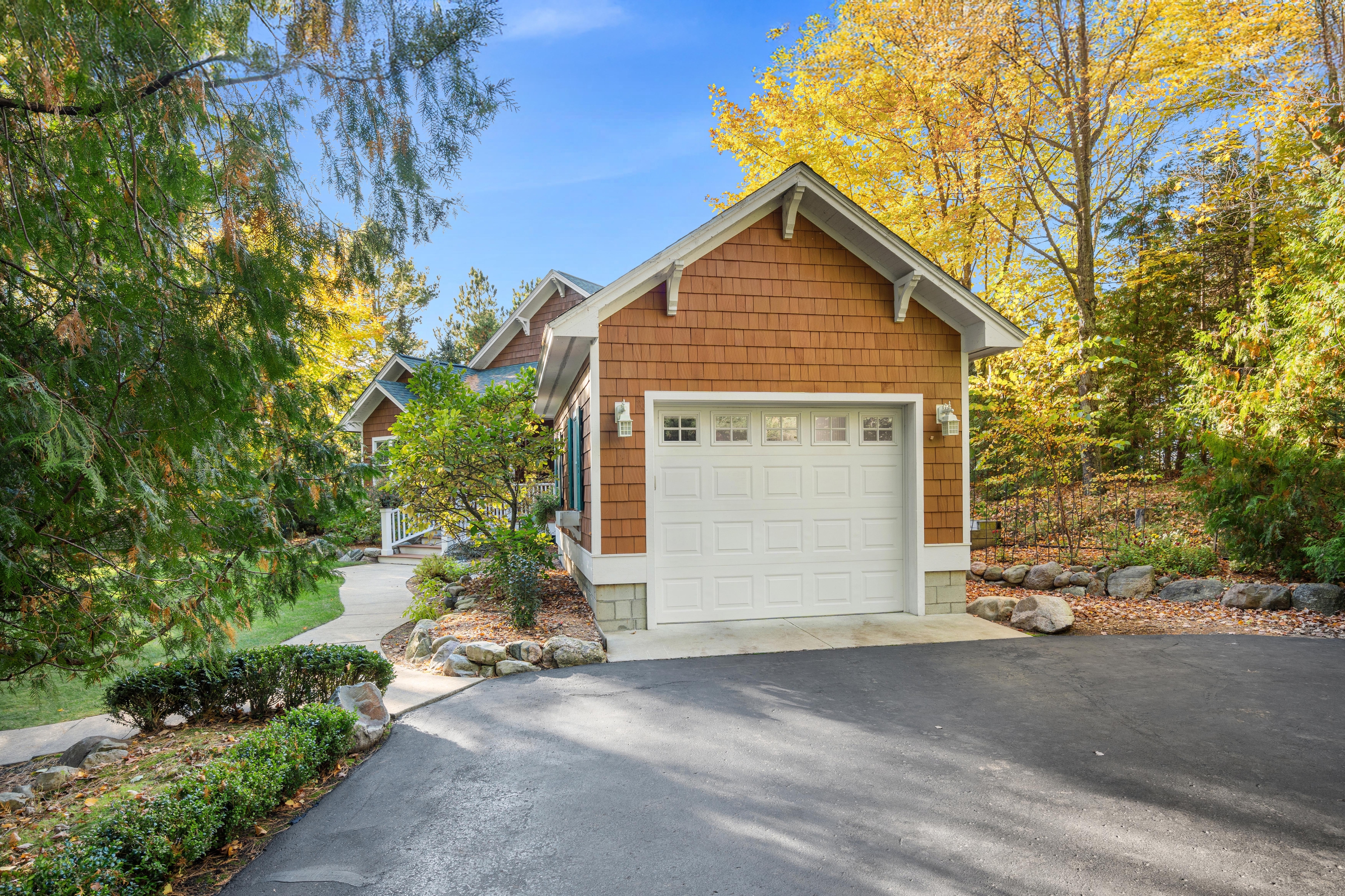 Exterior photographs of 4093 Lake Shore Drive in Charlevoix, this gem is listed at $2,099,900 through Berkshire Hathaway HomeServices Michigan Real Estate – Traverse City and The Crane Group with associate broker Johnny Crane and his brother, co-listing agent Matt Crane.