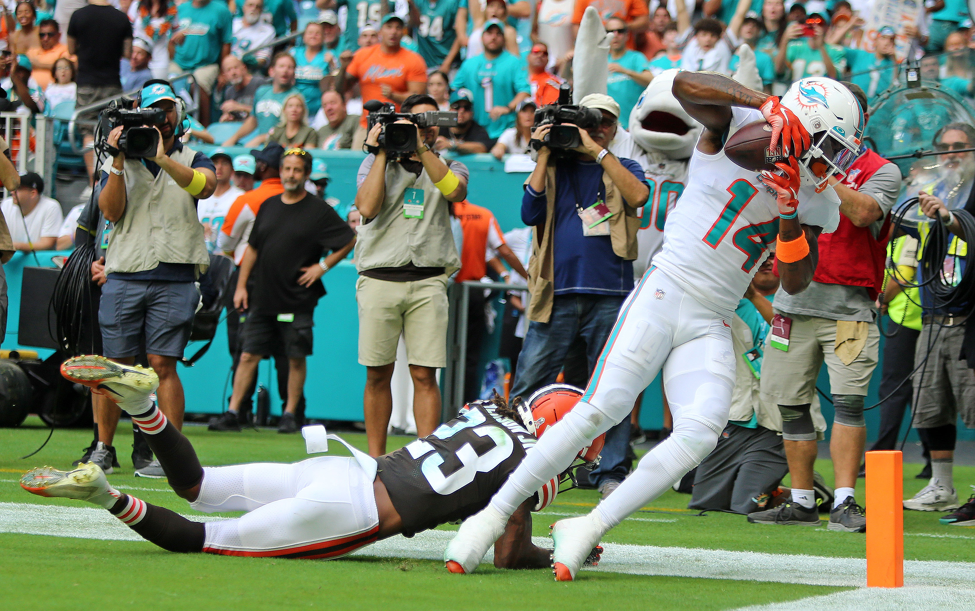 Miami Dolphins and Cleveland Browns players pose for photos after