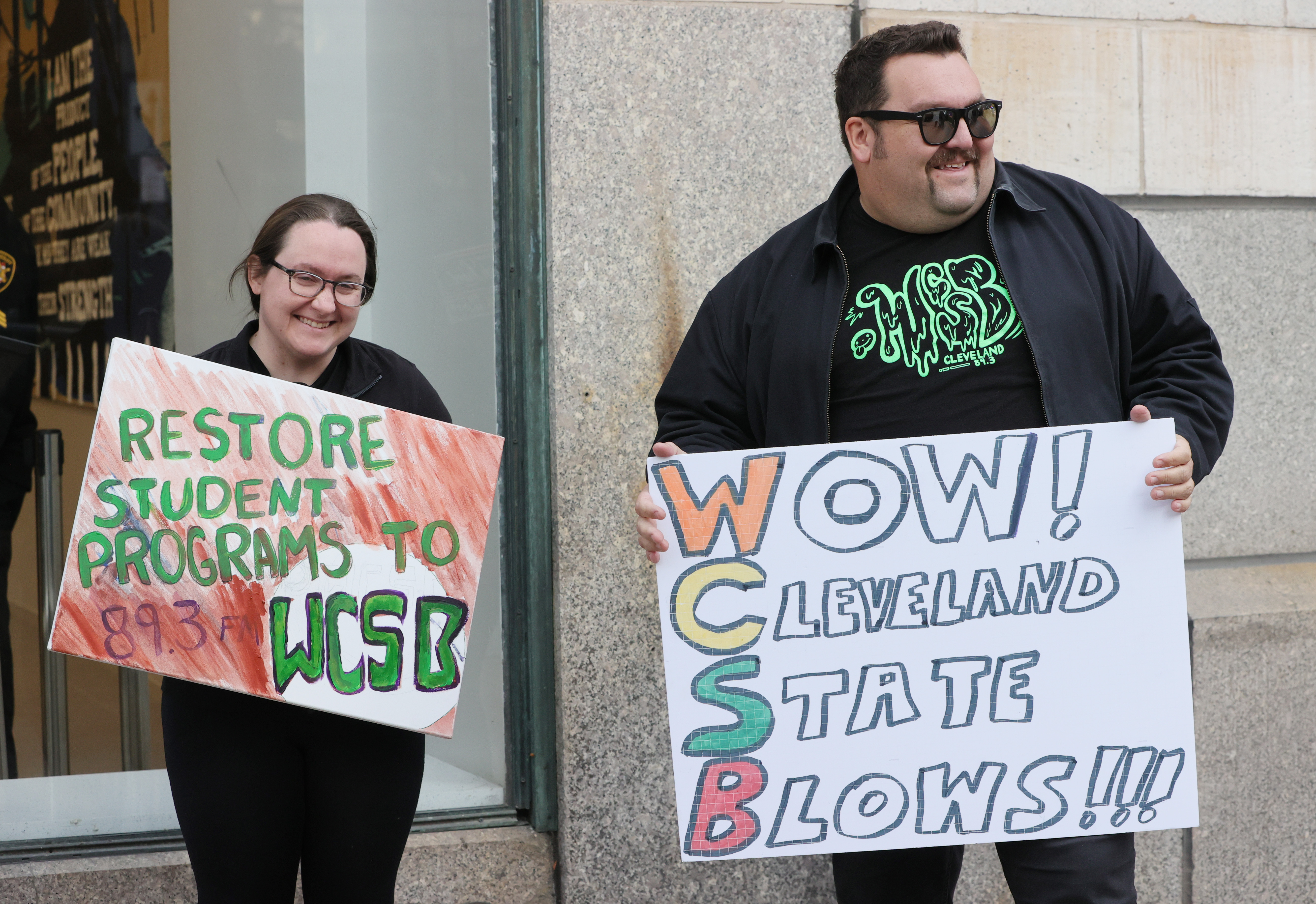Protestors rally outside Cleveland’s City Club during lunch forum with ...