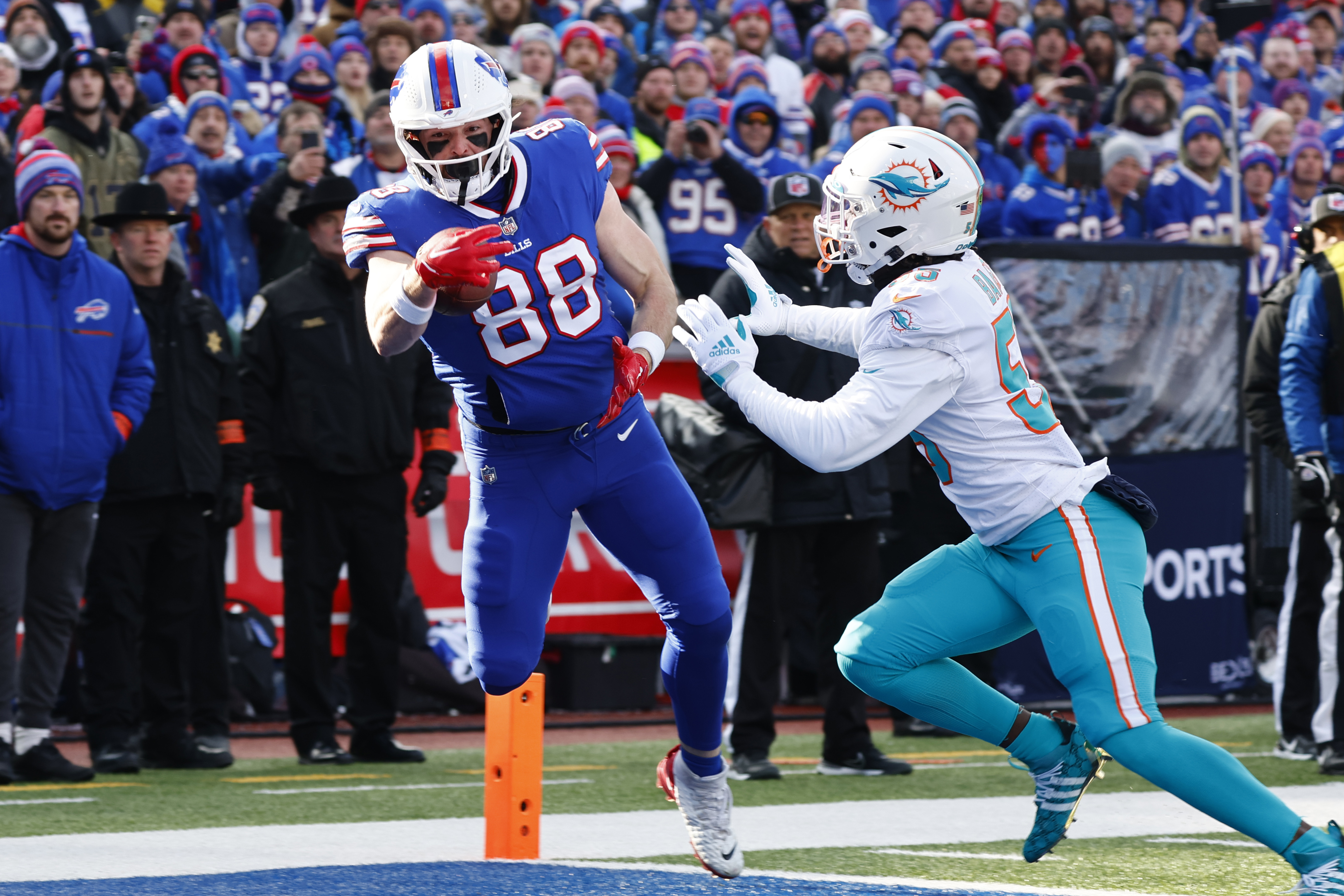 Buffalo Bills tight end Dawson Knox (88) catches a touchdown pass in front  of Miami Dolphins linebacker Jerome Baker (55) during an NFL wild-card  football game Sunday, Jan. 15, 2023, in Orchard