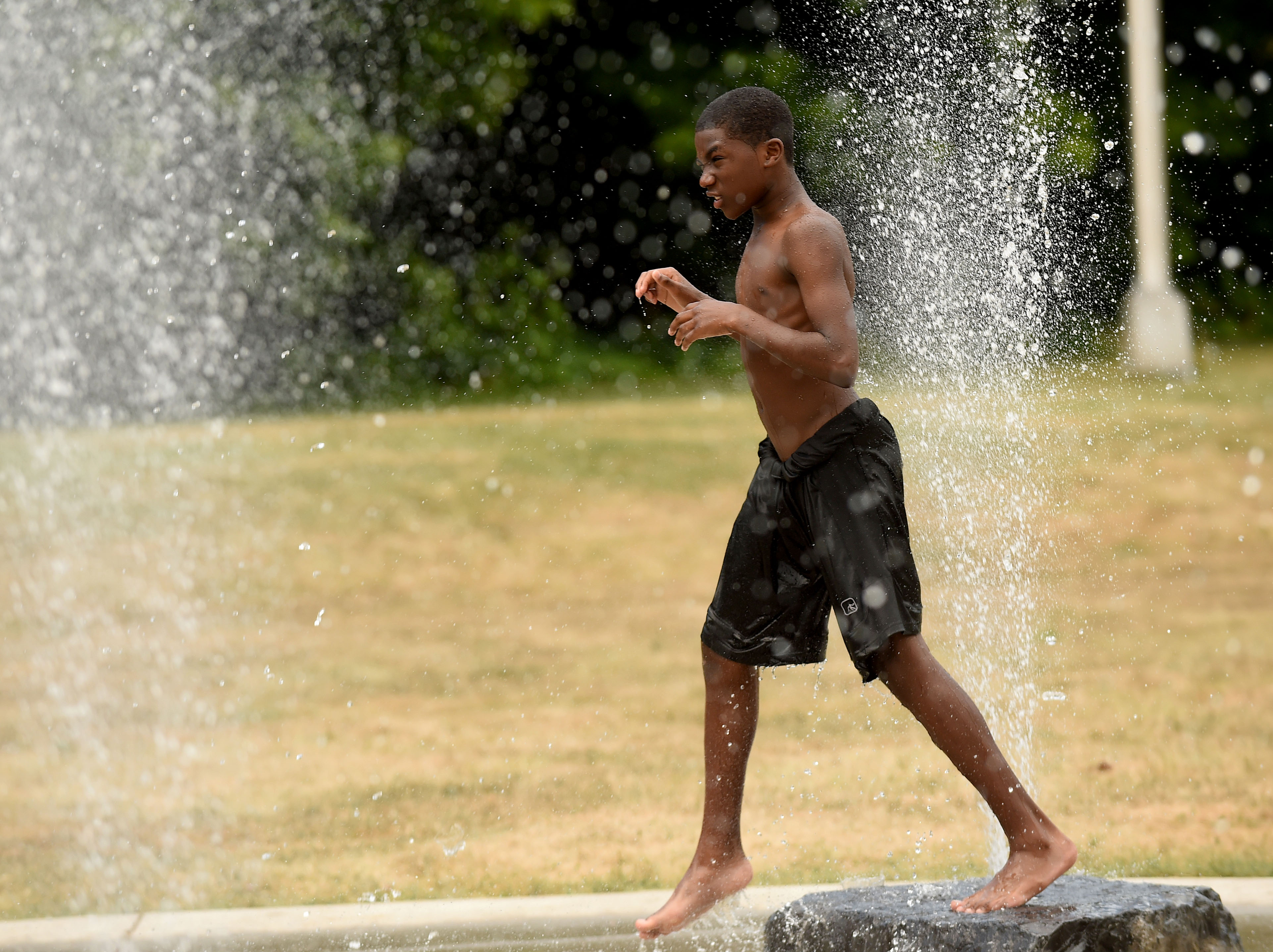 People are still looking for a way to cool down during a heat spell in Syracuse, July 8, 2020. 13 yr old Arthur Bullock steps off a fountain at the spray station at Lower Onondaga Park.  Dennis Nett | dnett@syracuse.com