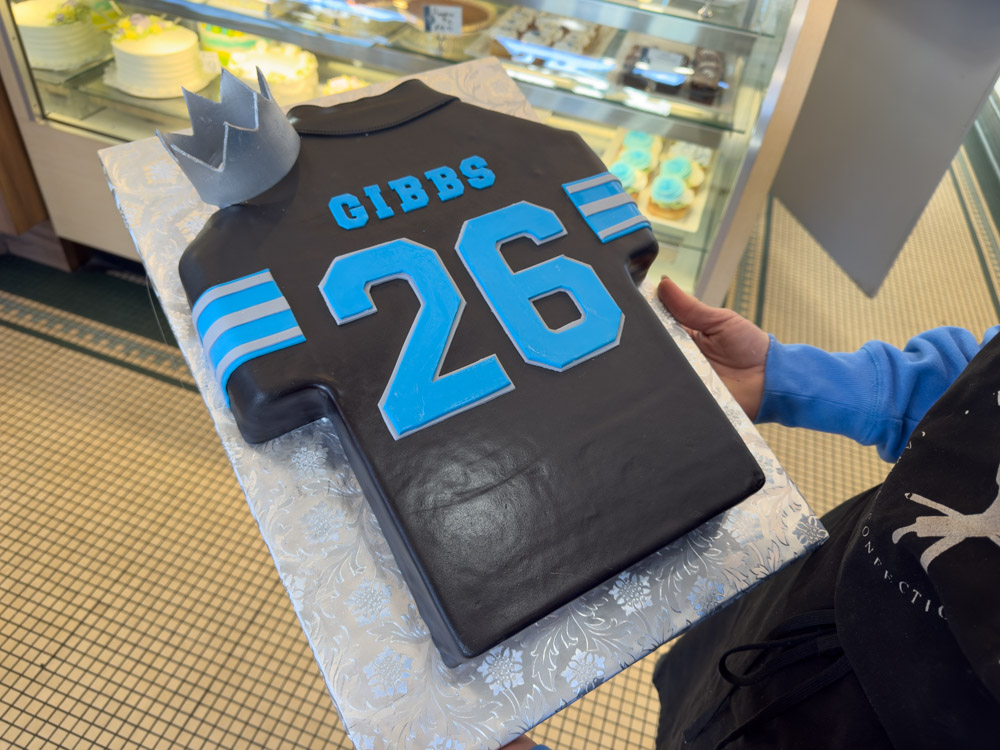 After Detroit Lions running back Jahmyr Gibbs concluded the 2024 season with 20 touchdowns — the most by any player— Heather Tocco created a small commemorative cake featuring a silver crown and replicating the Lions' black uniform worn by Gibbs during the game against the Minnesota Vikings when he set the record.