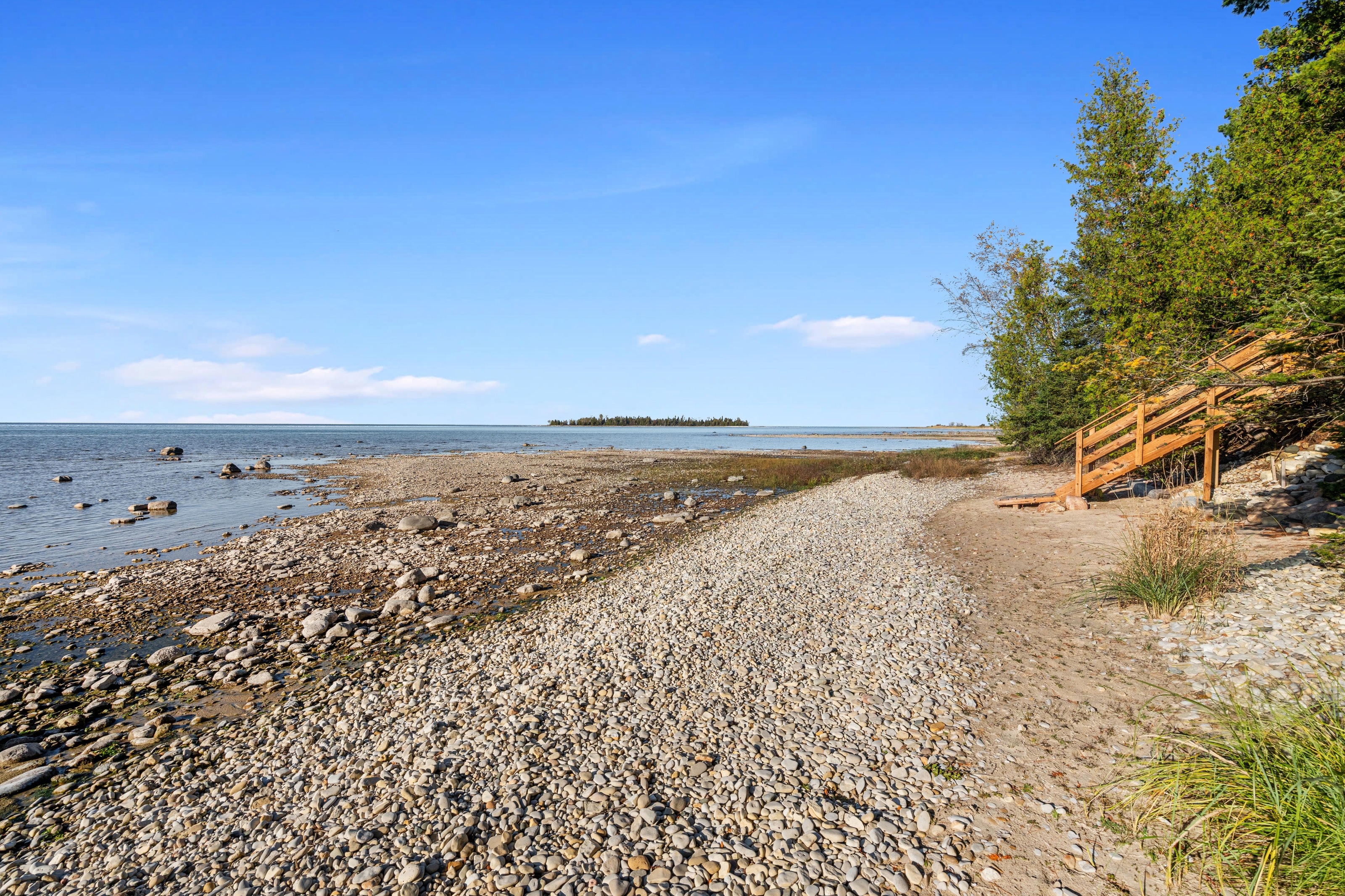 Exterior photographs of 4093 Lake Shore Drive in Charlevoix, this gem is listed at $2,099,900 through Berkshire Hathaway HomeServices Michigan Real Estate – Traverse City and The Crane Group with associate broker Johnny Crane and his brother, co-listing agent Matt Crane.
