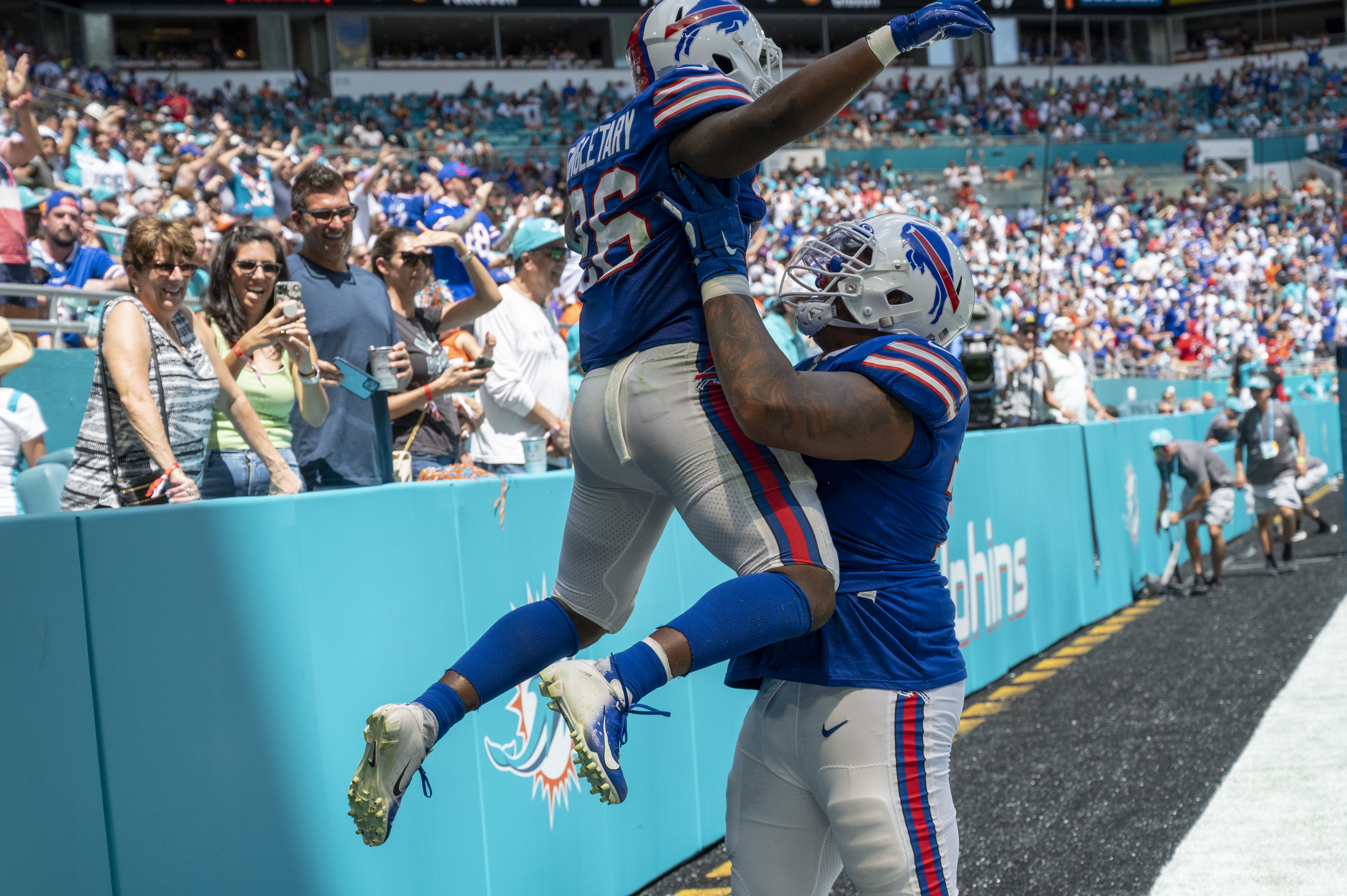 Miami Dolphins wide receiver Jaylen Waddle (17) is tackled by Buffalo Bills  cornerback Taron Johnson (7)