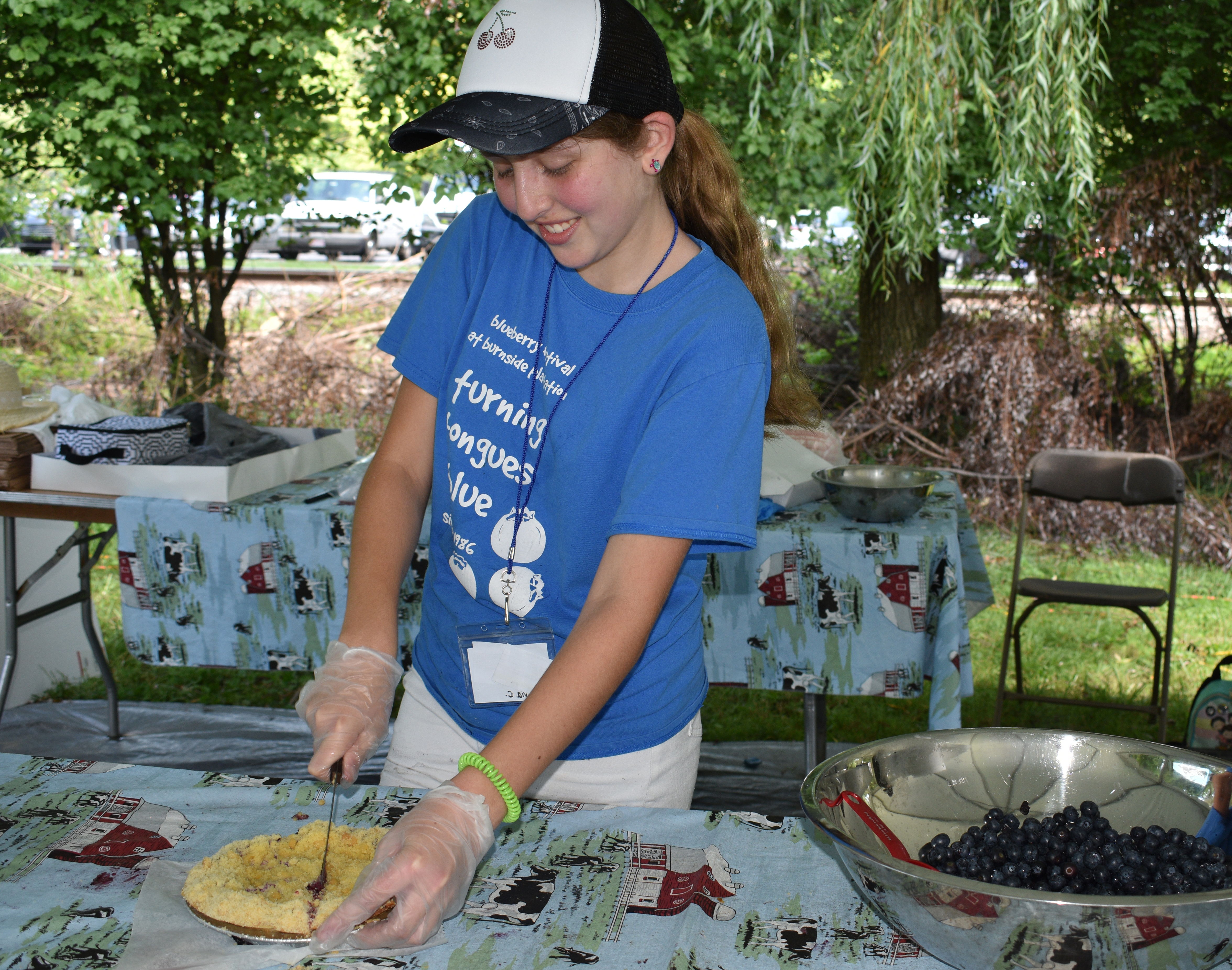 Olivia Caleca, a volunteer from Easton, cut servings of blueberry pie in the Dessert Tent as Historic Bethlehem Museums & Sites hosts the first of two days of its Blueberry Festival & Market To Go on Saturday, July 13, 2024, at Burnside Plantation.