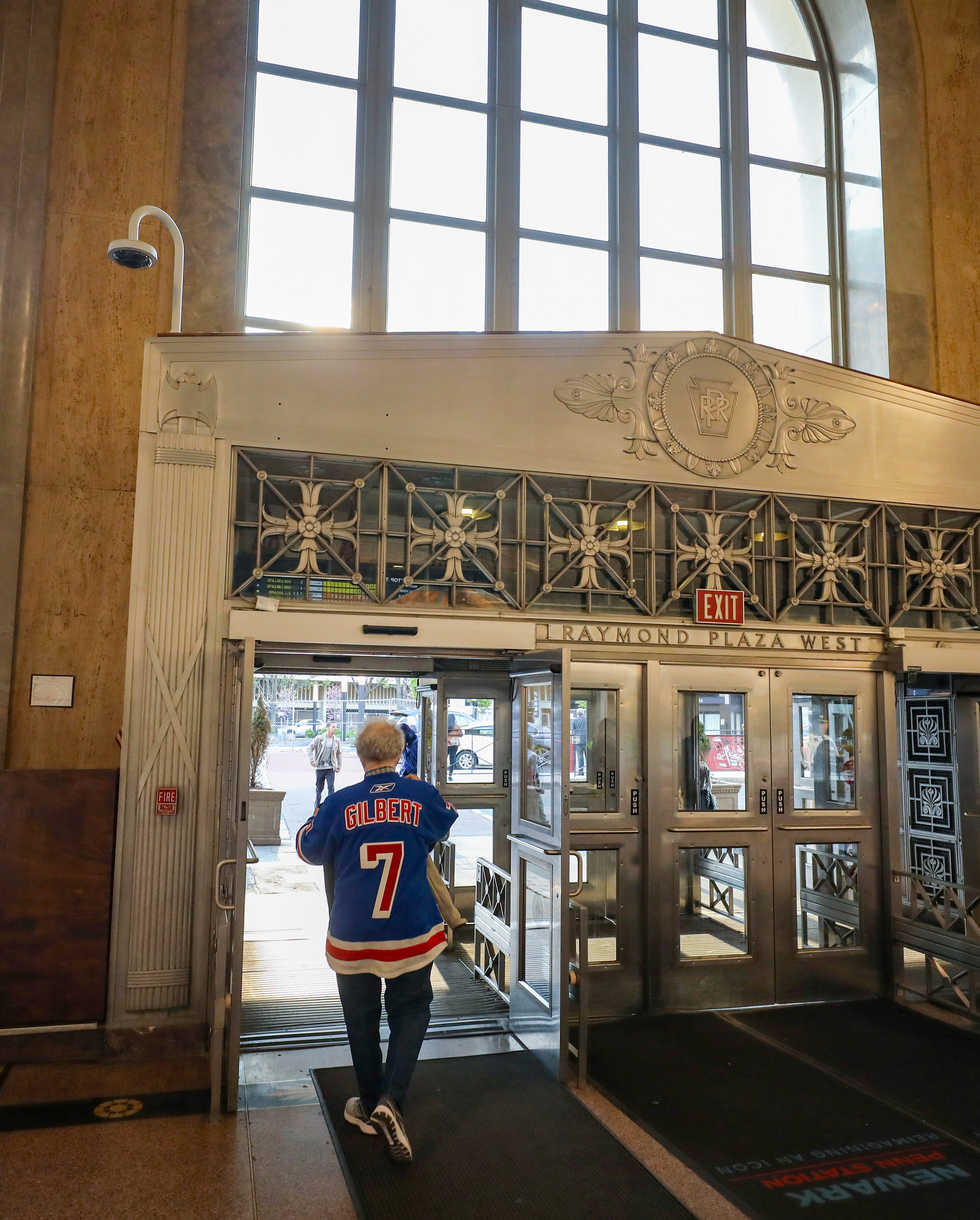 A fan wearing an old school Rod Gilbert No. 7 Rangers jersey leaves Newark Penn Station for the walk to Prudential Center a few blocks away to watch the New Jersey Devils and New York Rangers play Game 1 of the opening round of the Stanley Cup playoffs on Tuesday, April 18, 2023 in Newark, N.J. 