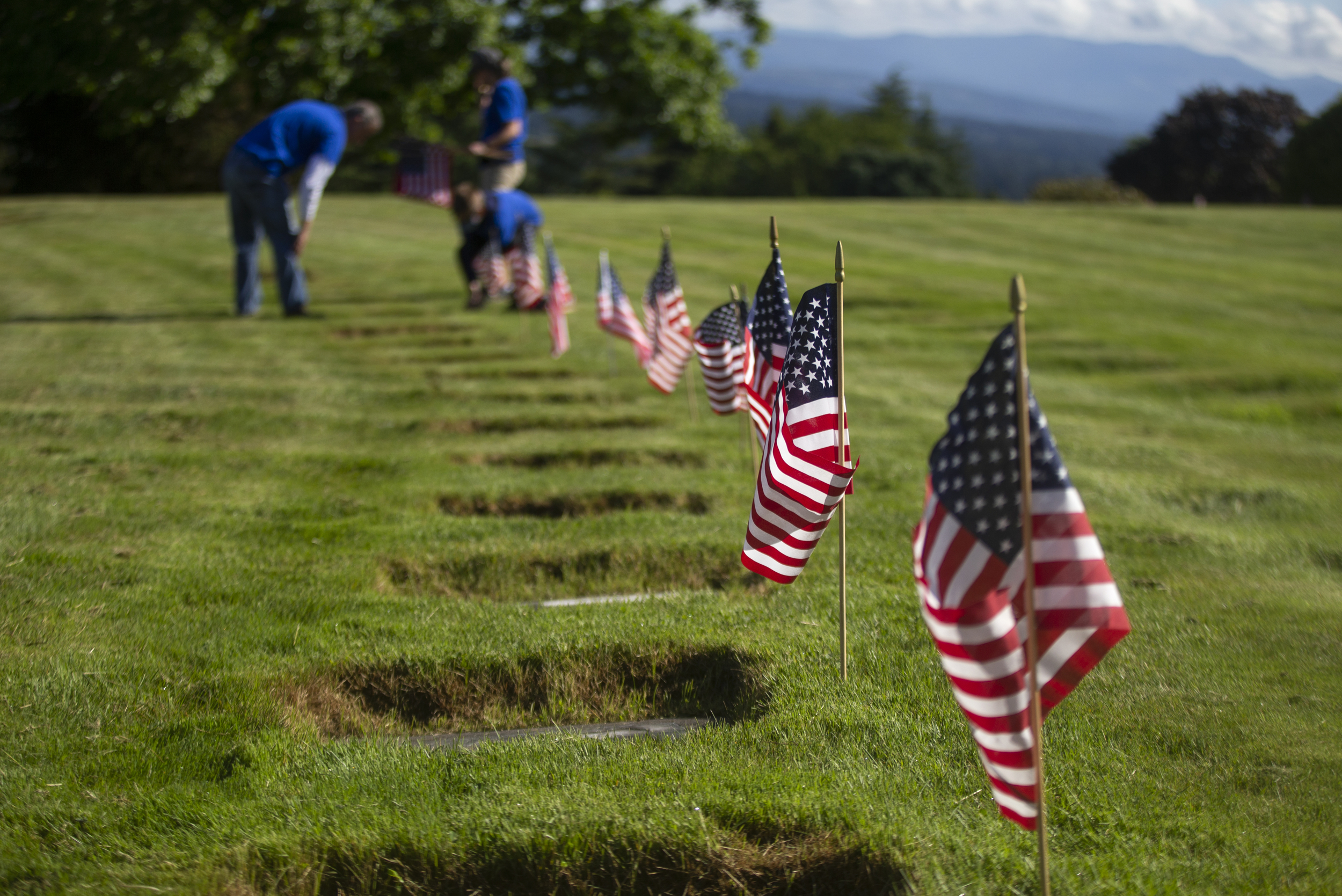 Local volunteers place flags on veterans' graves in honor of Memorial Day, News