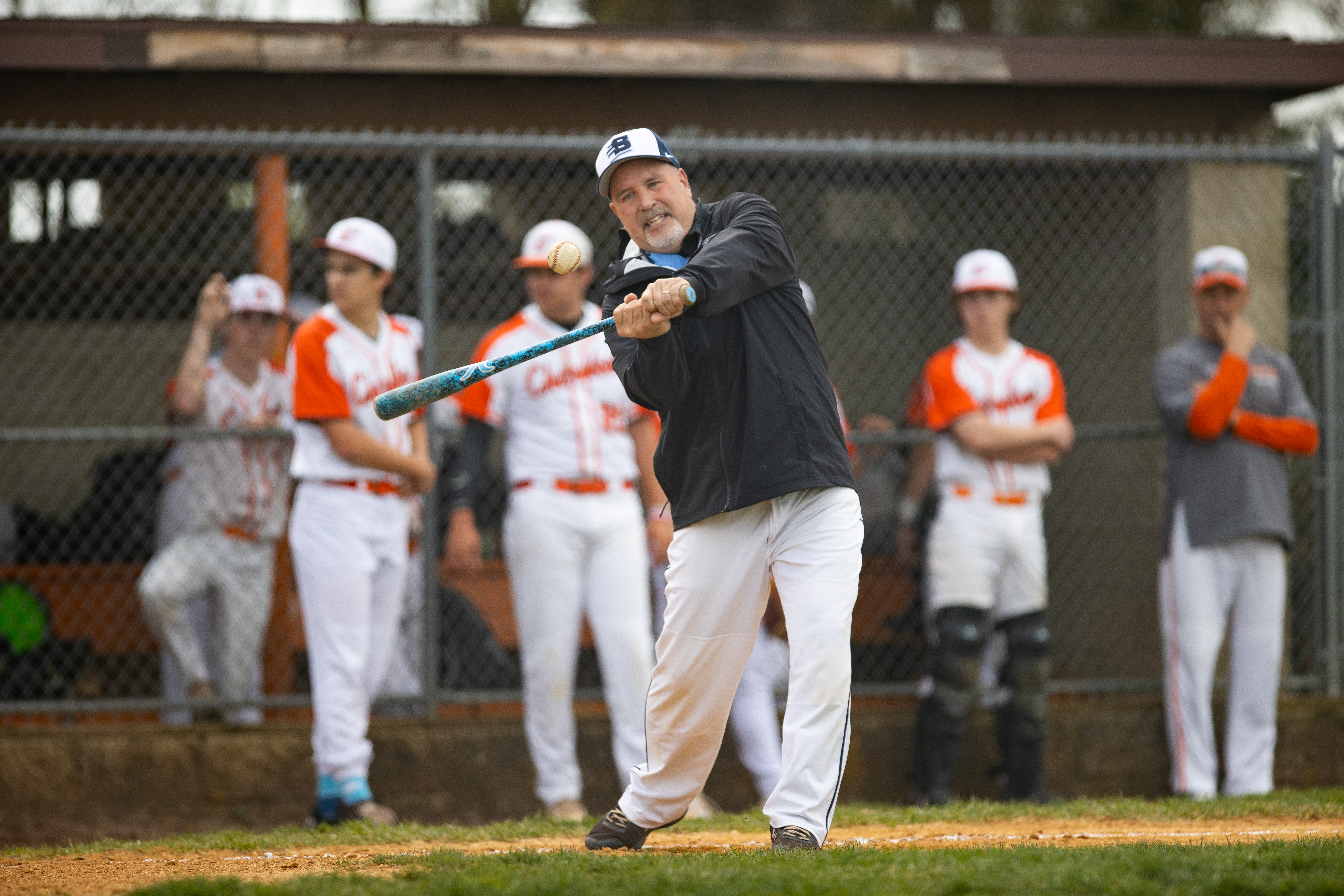 Head Coach Brian Anderson, of Shawnee, hits to players for warm ups in Marlton, NJ on Monday, April 3, 2023.