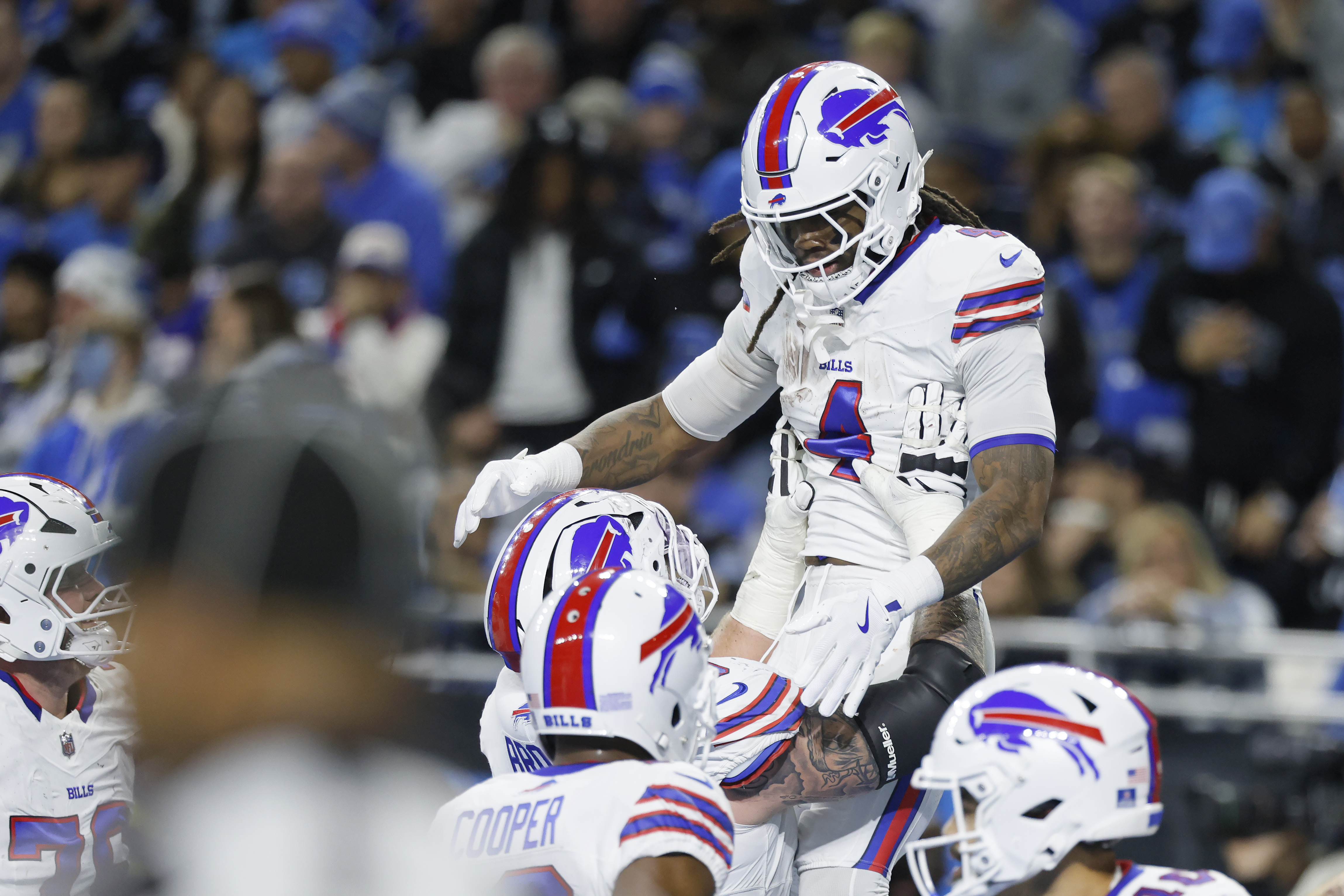 Buffalo Bills running back James Cook, top, celebrates with teammates after scoring against the Detroit Lions during the first half of an NFL football game, Sunday, Dec. 15, 2024, in Detroit. (AP Photo/Duane Burleson)