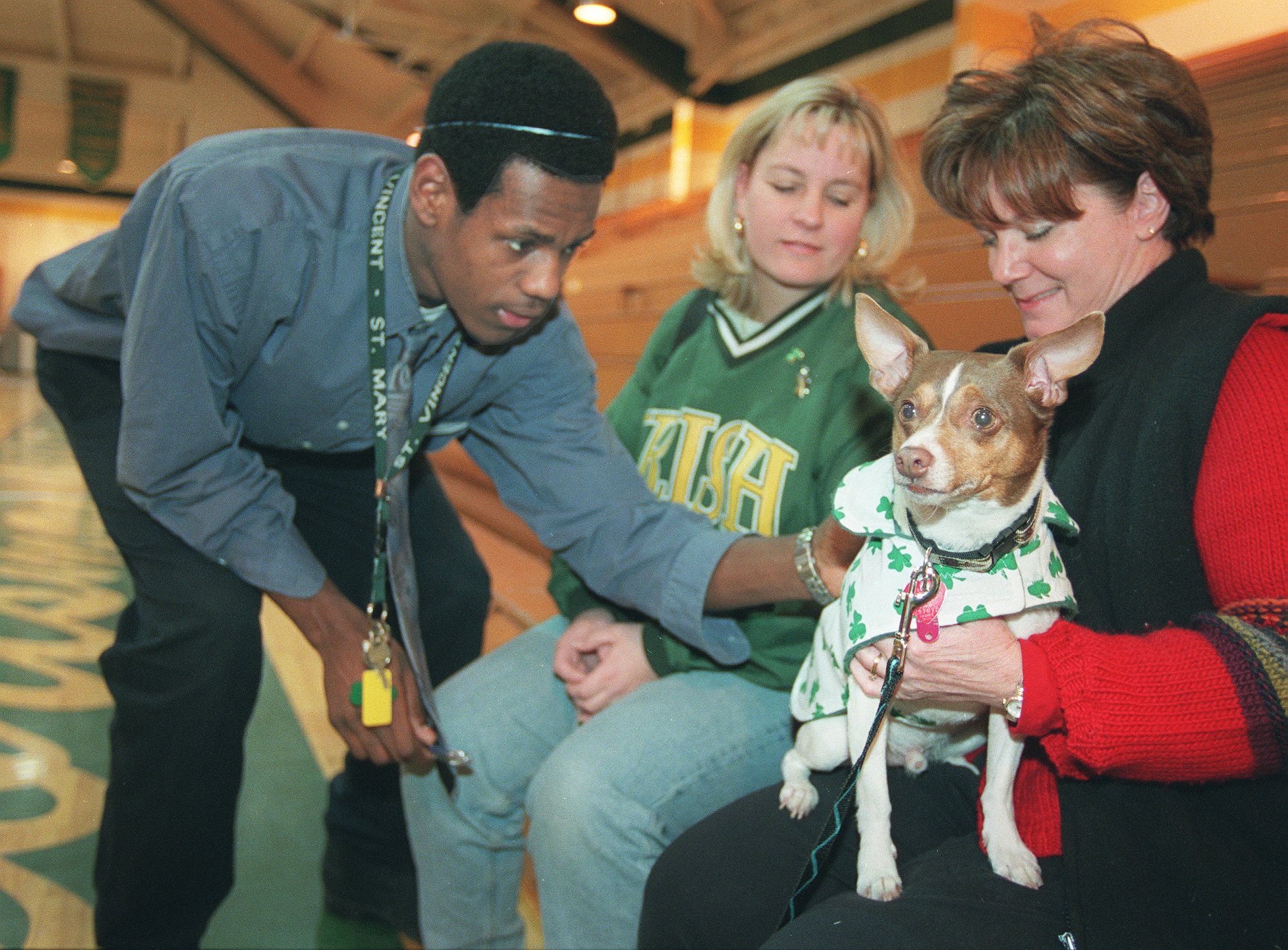 SVSM students gathered in the school's gym to honor the basketball team , the cheerleaders, and the state champ wrestling team Wednesday afternoon.  Just before the start fo the rally, LeBron James, a SVSM basketball standout, signed Eddie's ( toy fox terrier)shamrock jacket. (Bill Kennedy/The Plain Dealer)